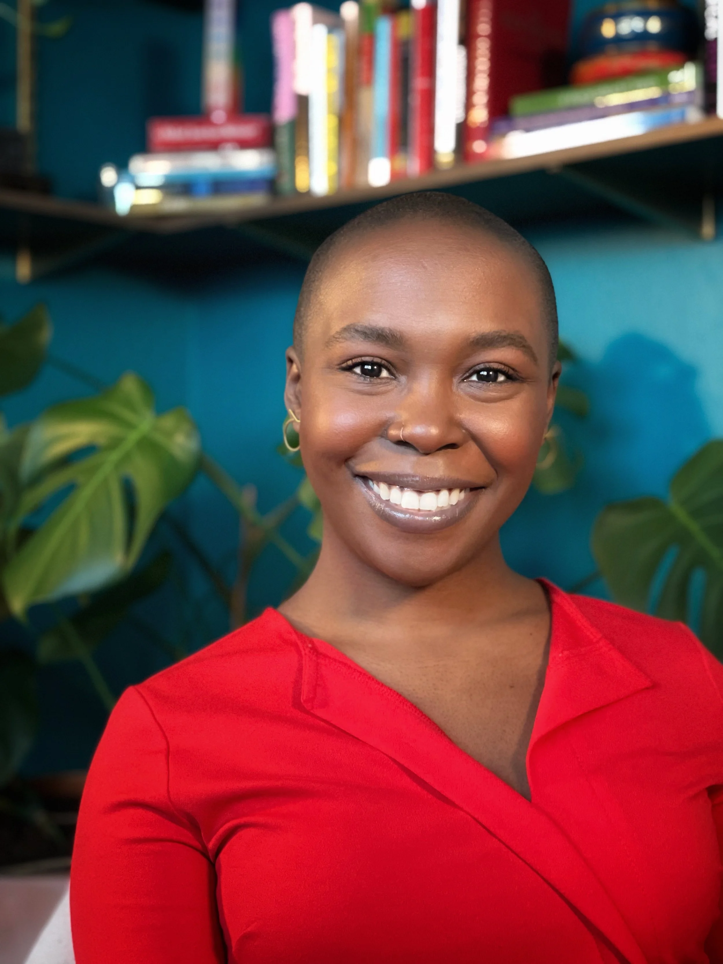 Black woman Questella in therapy practice smiling