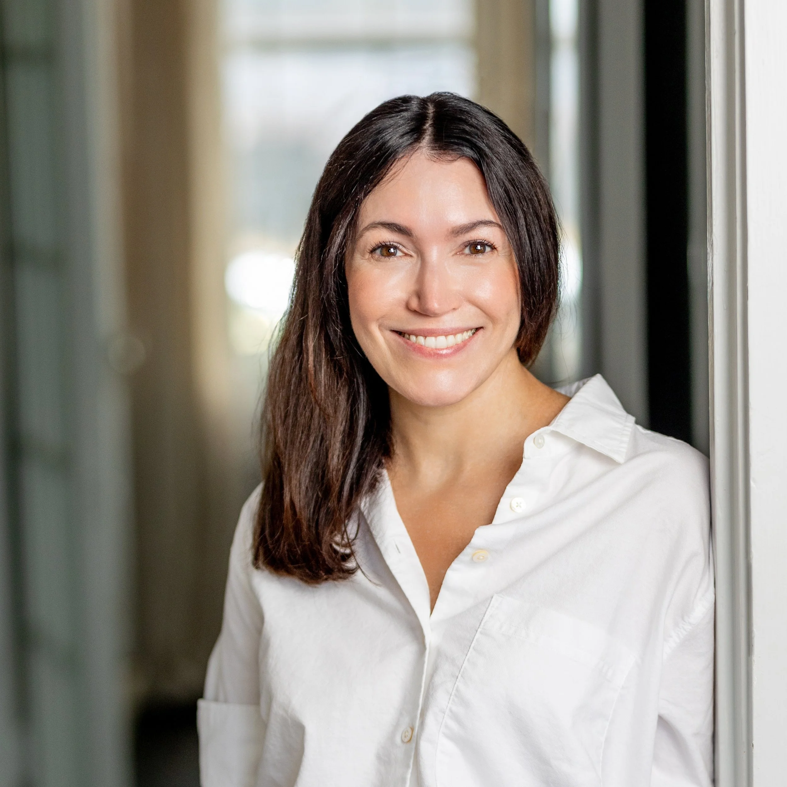 Sara Miller, maternal mental health specialist in Austin, offering a warm and supportive smile to women navigating the transition to motherhood