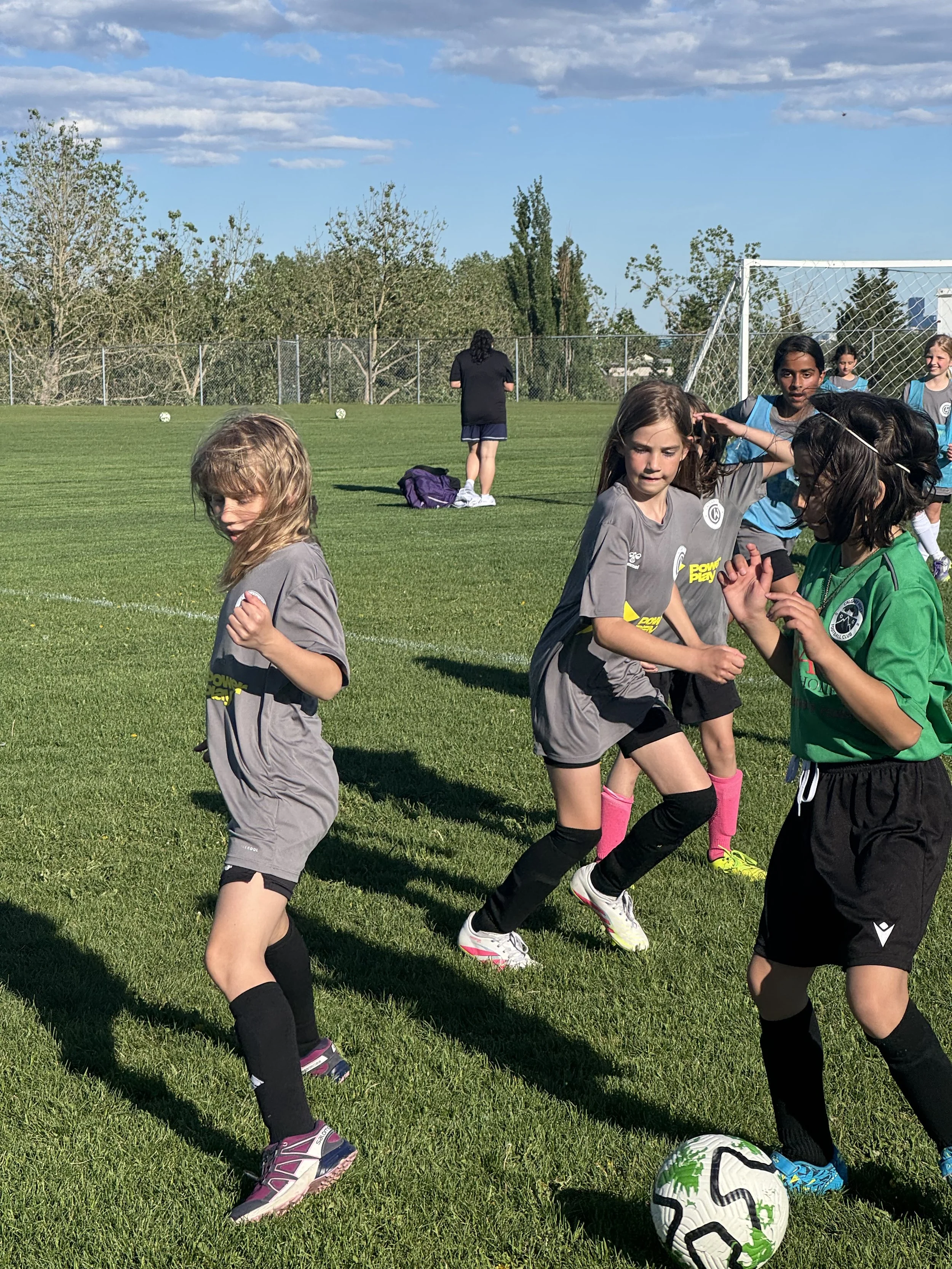 Indoor soccer training session for children in a large, enclosed dome with children practicing and coaching.