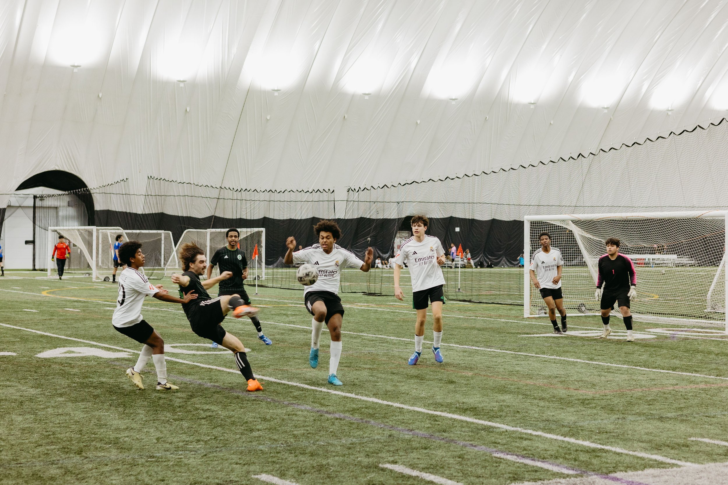 men-in-soccer-uniforms-kicking-soccer-ball.jpg