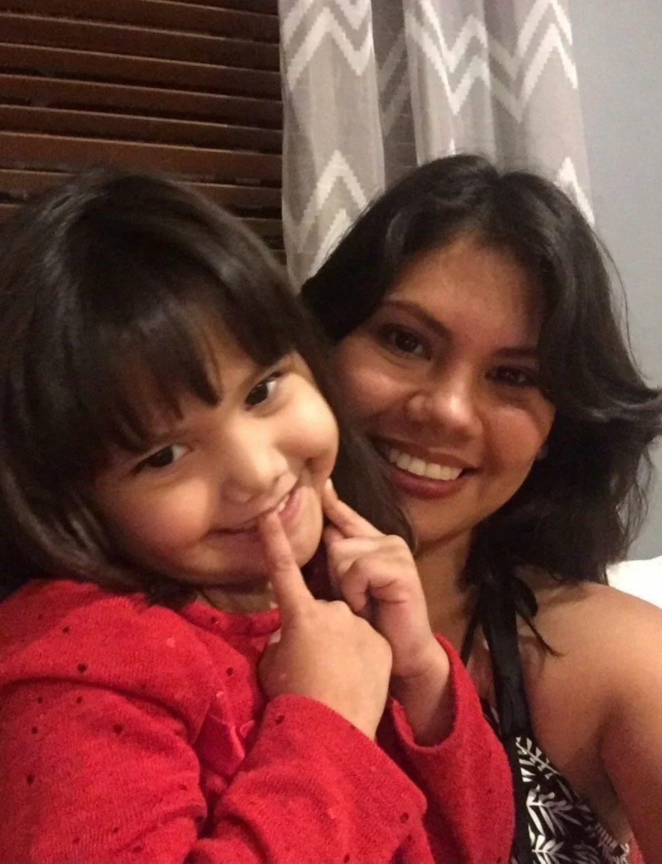 smiling mom and girl with red sweater and bangs