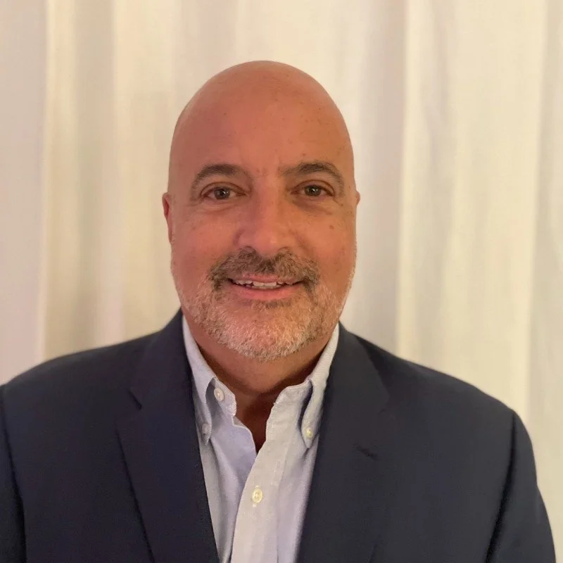 Portrait of a man in a suit with a geometric background