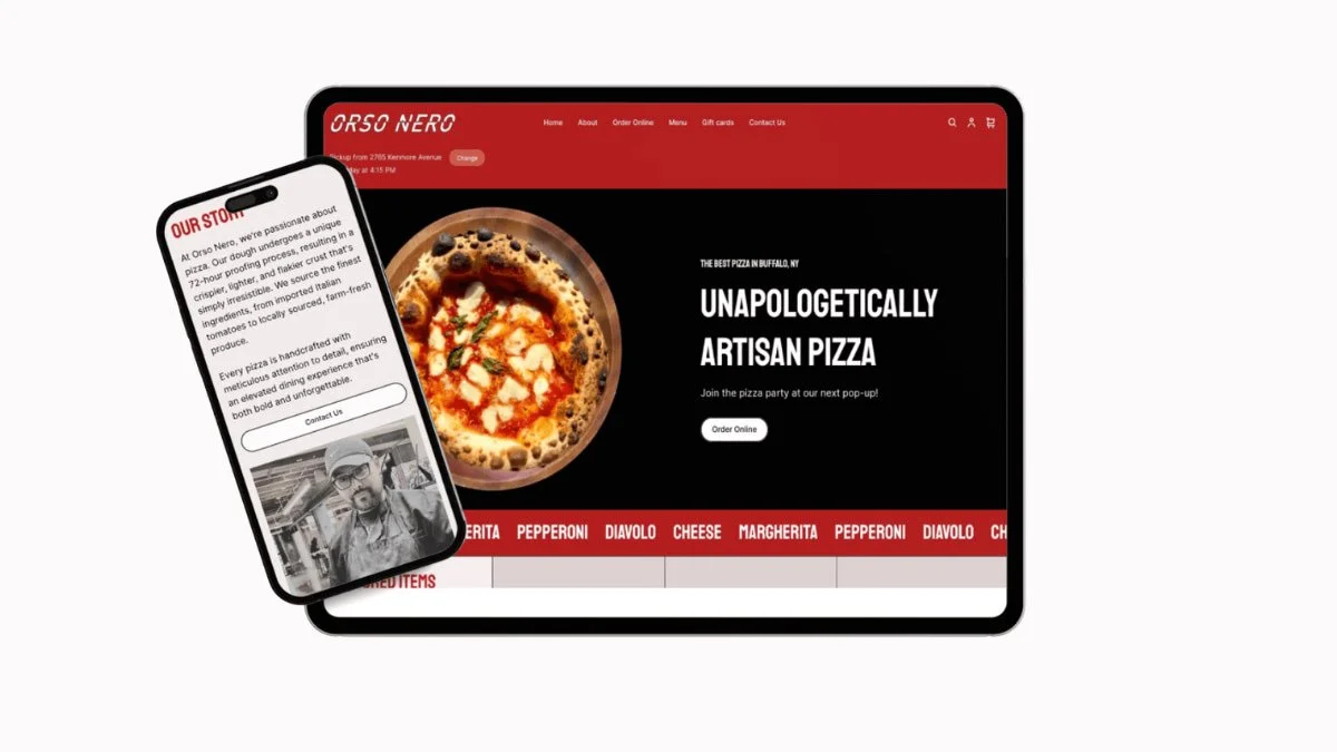 A tablet and a smartphone displaying a pizza restaurant's website. The website features a close-up of a pizza and text promoting artisan pizza, with menu items listed in red.
