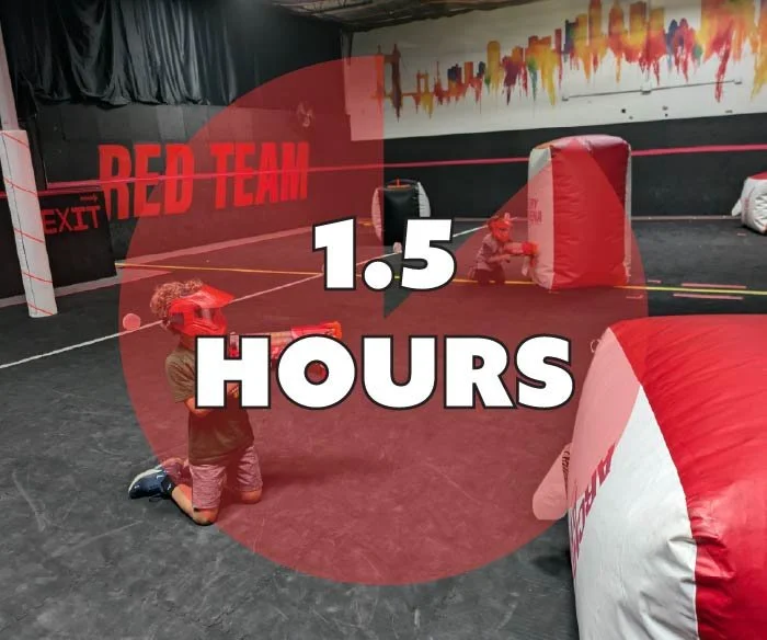 Two children playing laser tag in an indoor arena with black walls, red team signs, and inflatable barriers, with the caption '1.5 HOURS' displayed over the image.