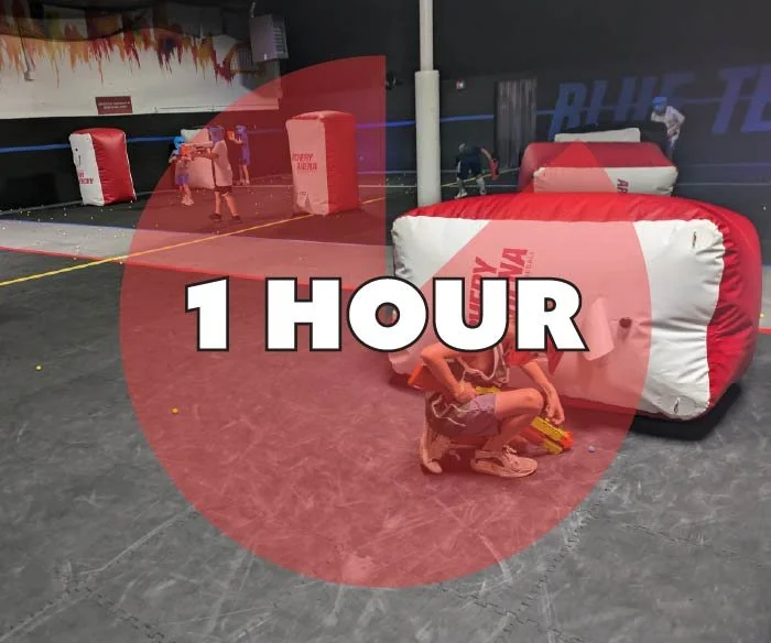 Children playing laser tag in an indoor arena with inflatable barriers, with a red overlay that says '1 HOUR'.