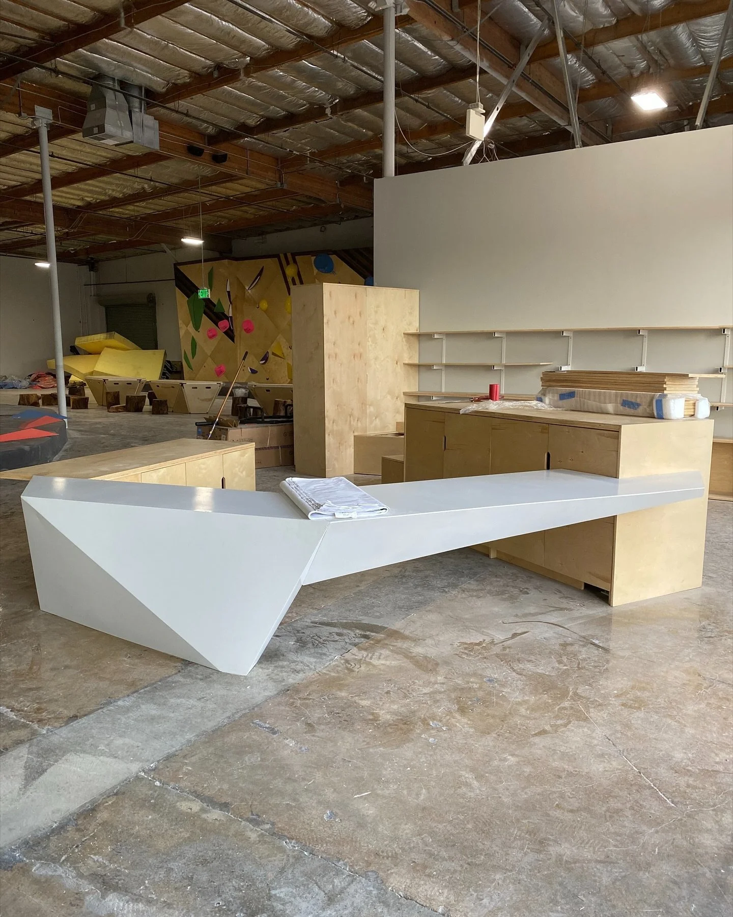 This project goes back a few years &mdash; and we&rsquo;re not even sure if we ever shared photos of it!

The @grottoclimbing Gym in Miramar features our design for the reception desk, shelving, and layout. 

Geometric forms inspired by rock formatio