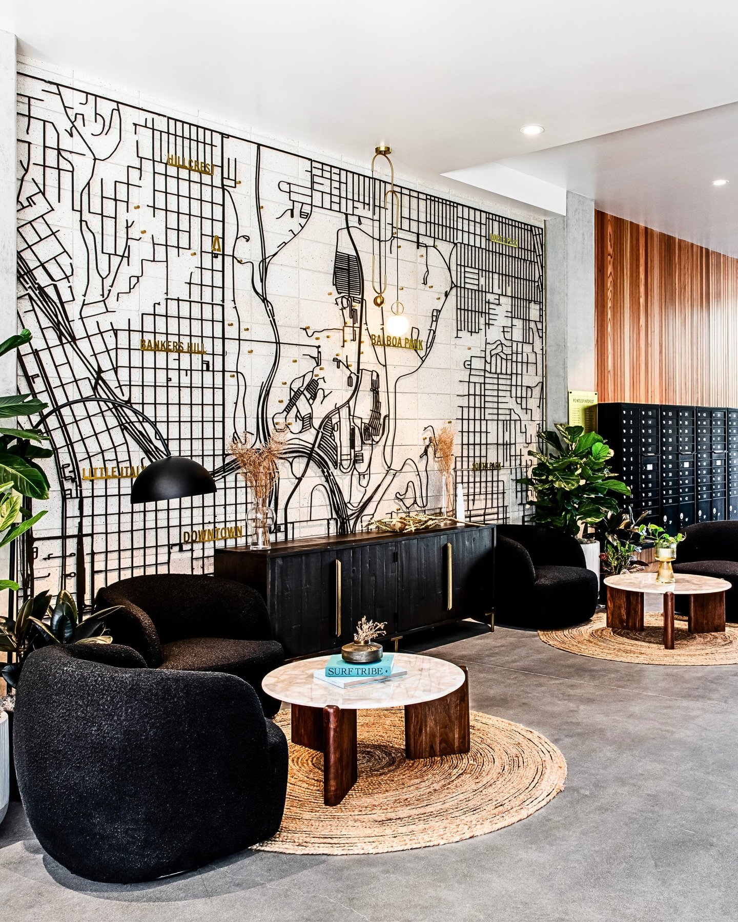 Designing belonging at scale.

Inspired by the tones of the Pacific and the raw textures of concrete and steel, this lobby was designed to create an immediate sense of place while supporting leasing performance.

A custom laser-cut steel feature wall
