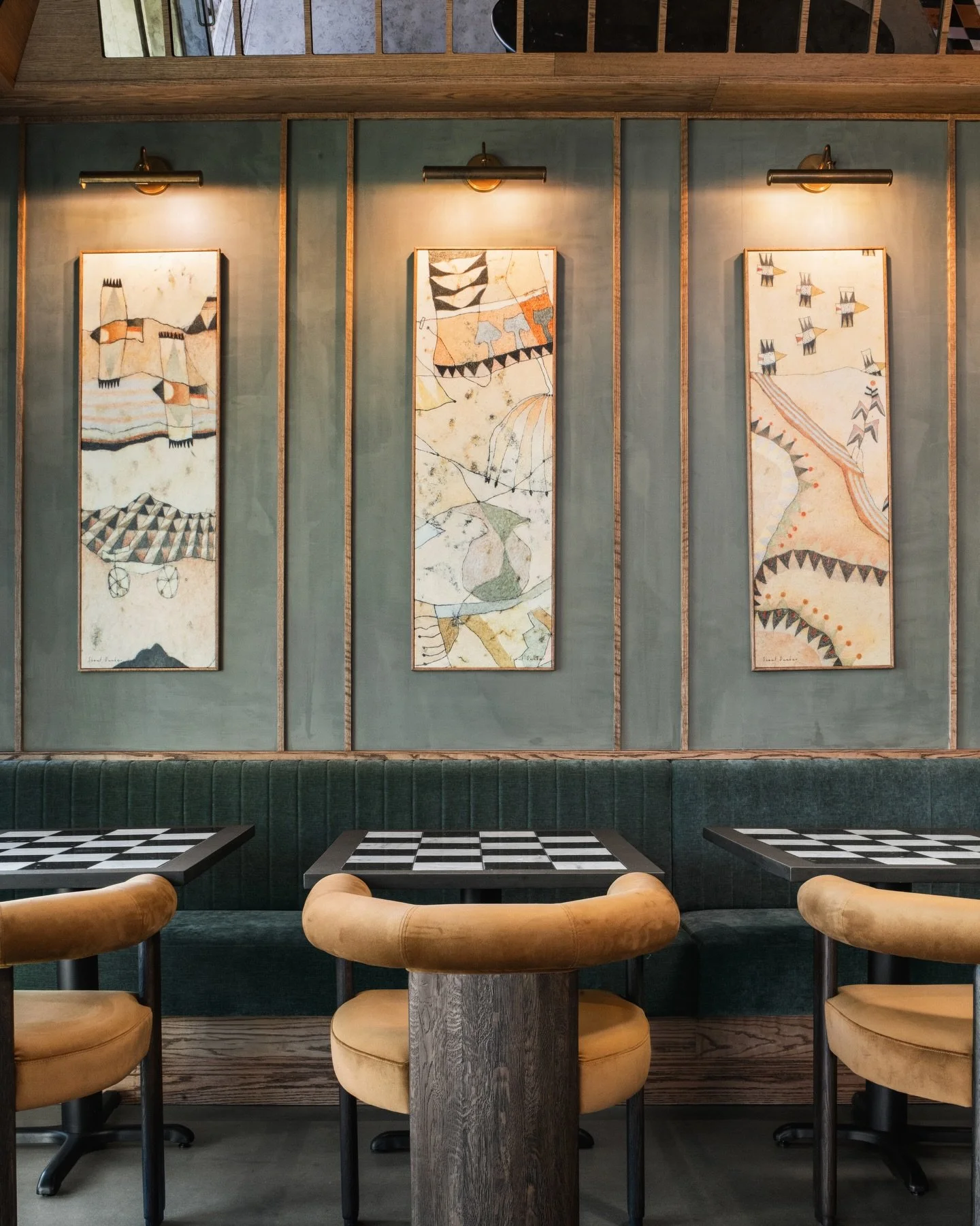 One standout feature of this caf&eacute; is the art wall, topped with an angled antique mirrored soffit. The work by Scout Dunbar was the perfect fit for the space.

Artist: @scoutdunbar 
Photos by: @auda__auda_photography