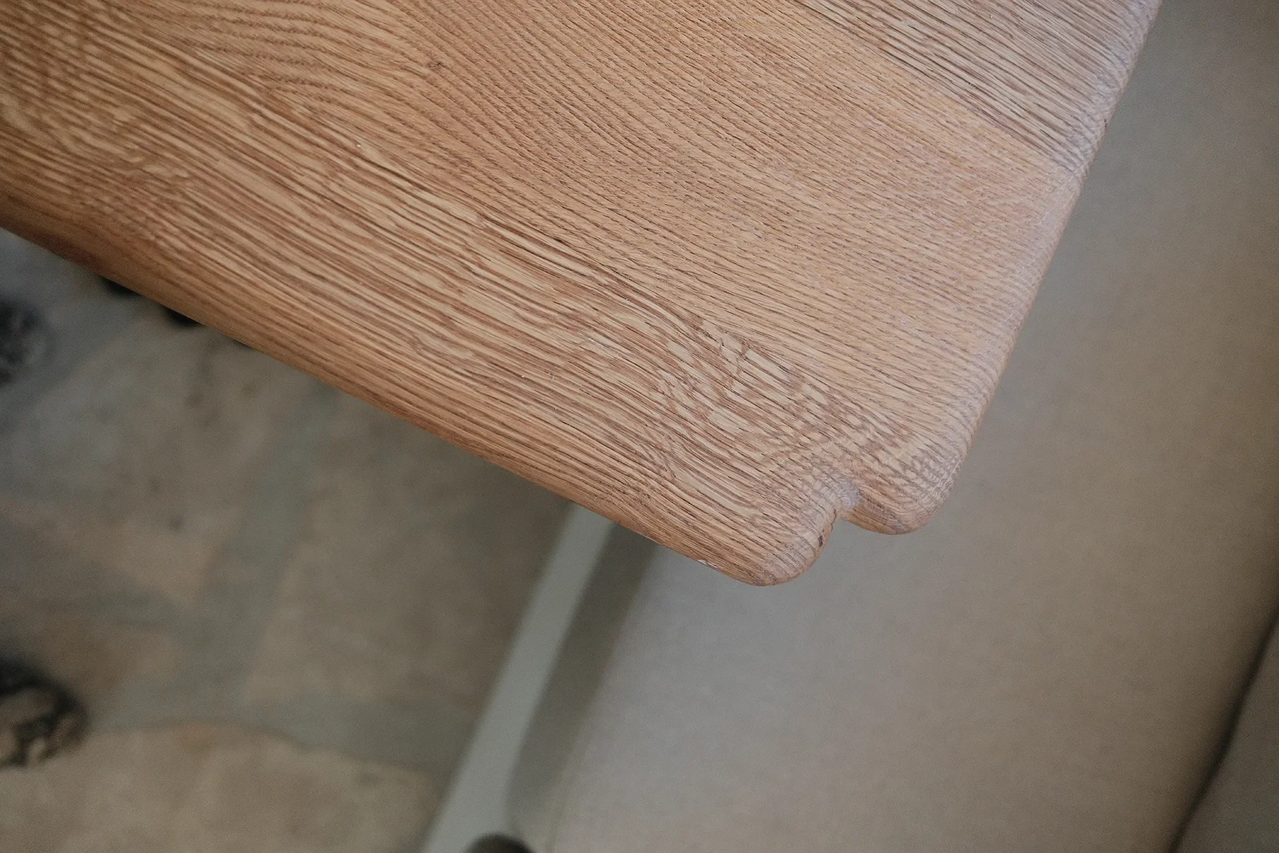Close detail of the cerused oak edge and rounded corner on a custom table at By The Sea, Coronado
