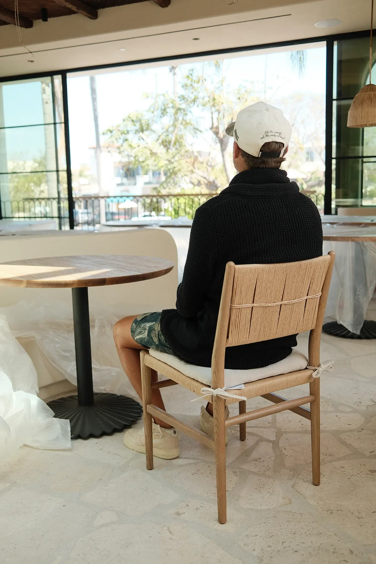 Trying a woven-back oak dining chair in place at By The Sea, tables still under protective plastic
