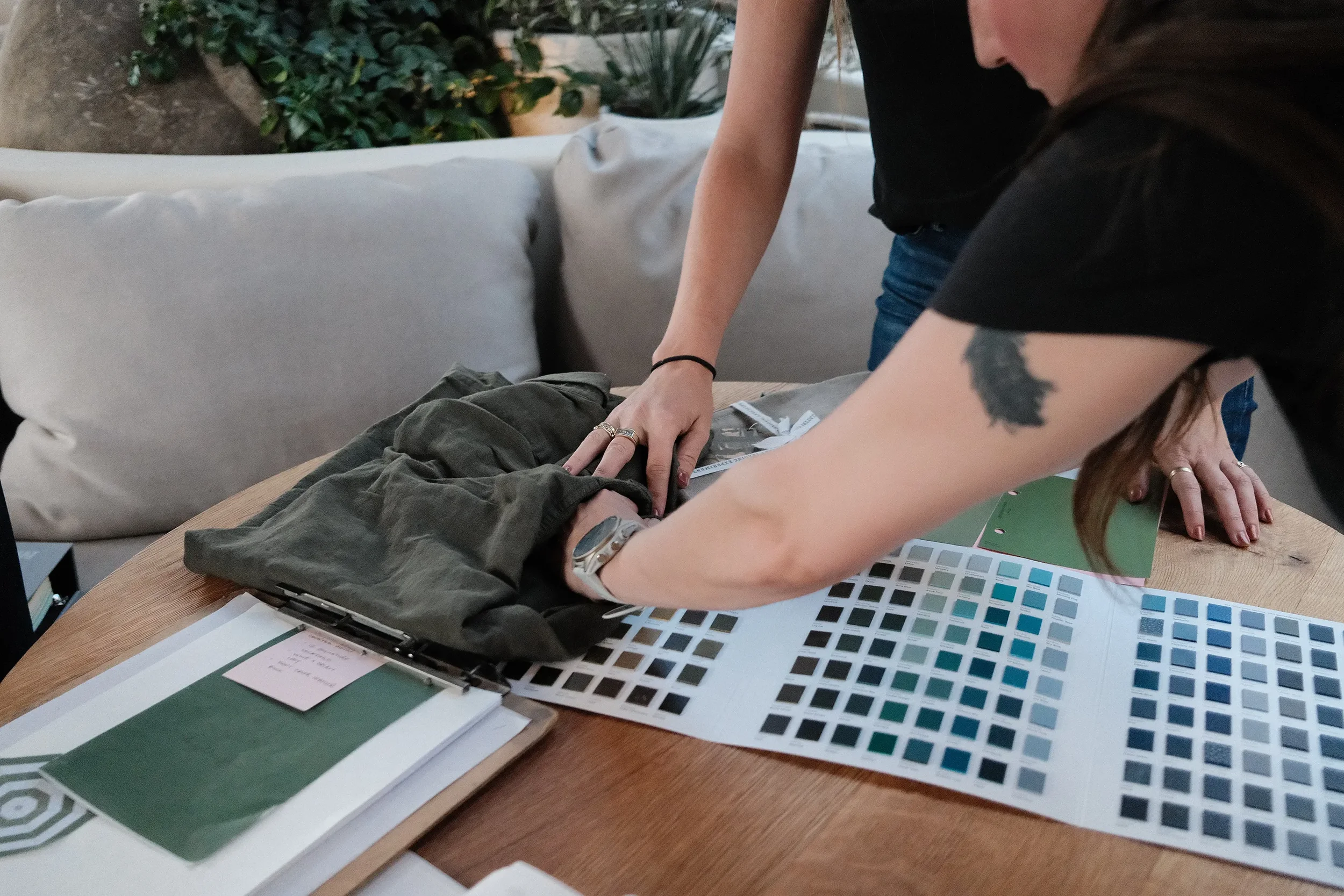 Comparing upholstery fabric against color and tile swatch boards in a By The Sea selections meeting