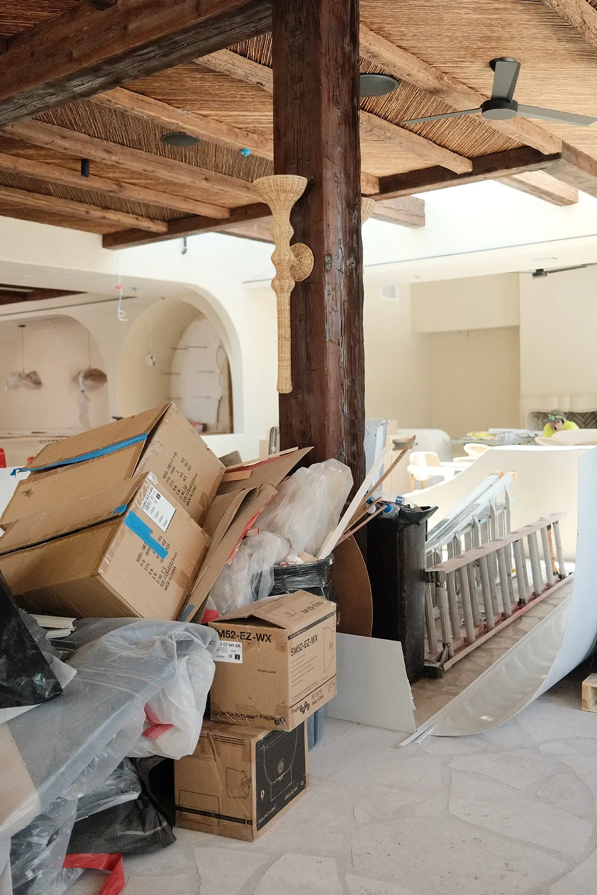 Furniture cartons and a ladder sitting under the willow reed ceiling at By The Sea in Coronado