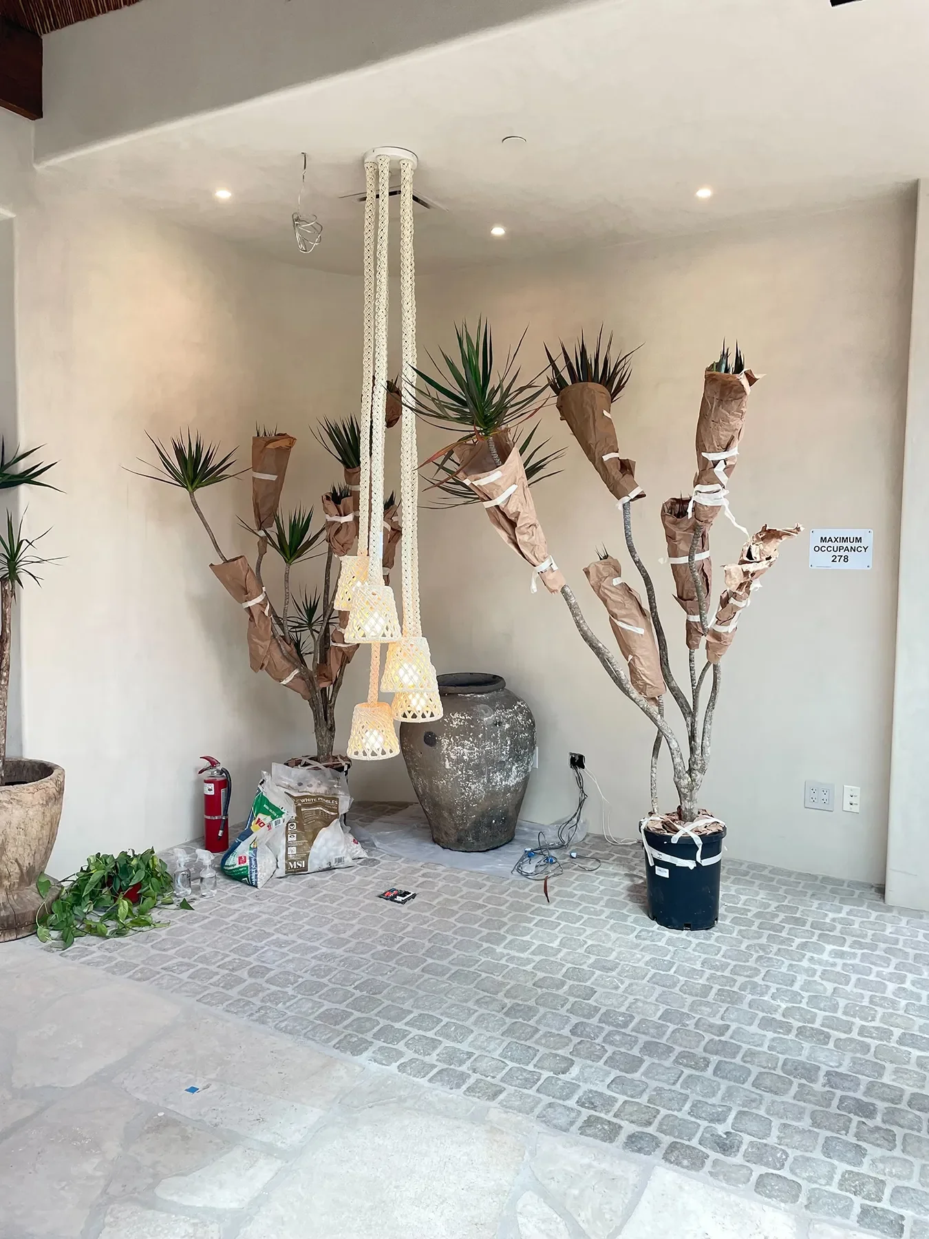 Where flagstone meets cobblestone at By The Sea, with pendants and planting waiting to be set