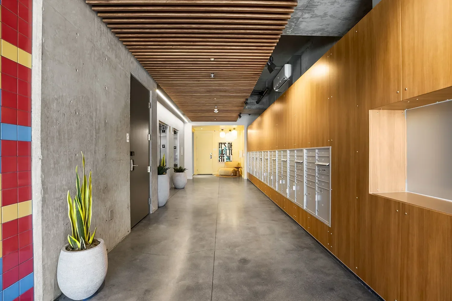 multifamily-mail-room-cedar-lockers-slat-ceiling.webp