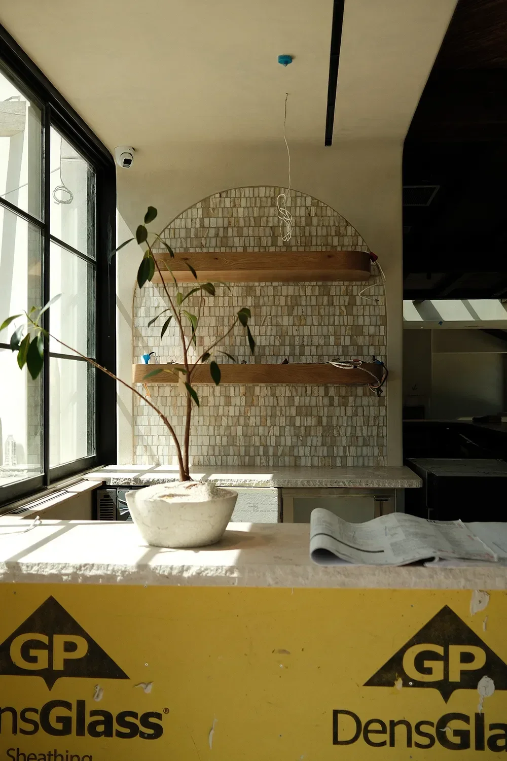by-the-sea-coronado-plaster-stone-arched-niche-oak-wood-shelving.webp