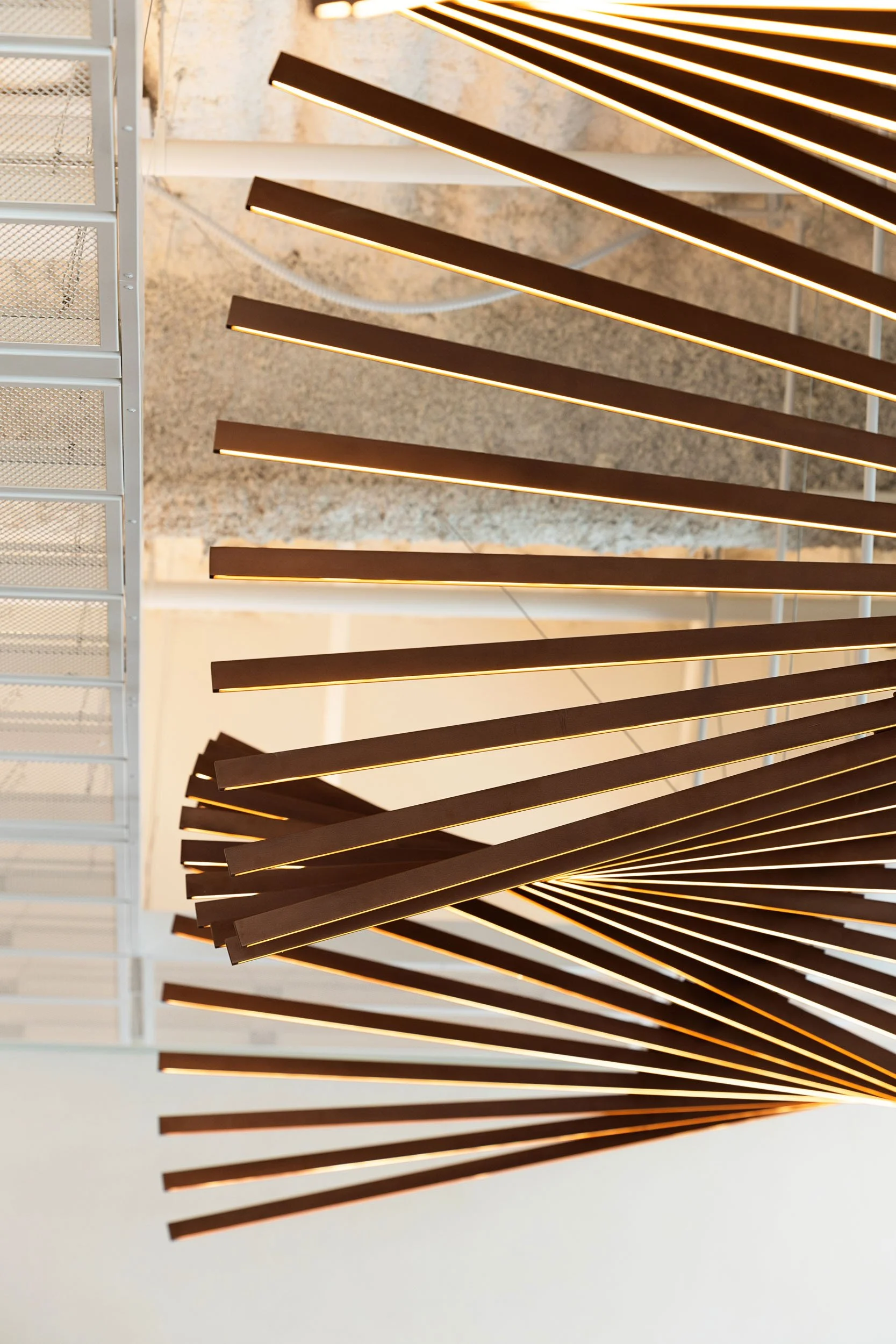 Detail of Articulation's undulating metal slats creating the architectural lighting feature in the commercial lobby.