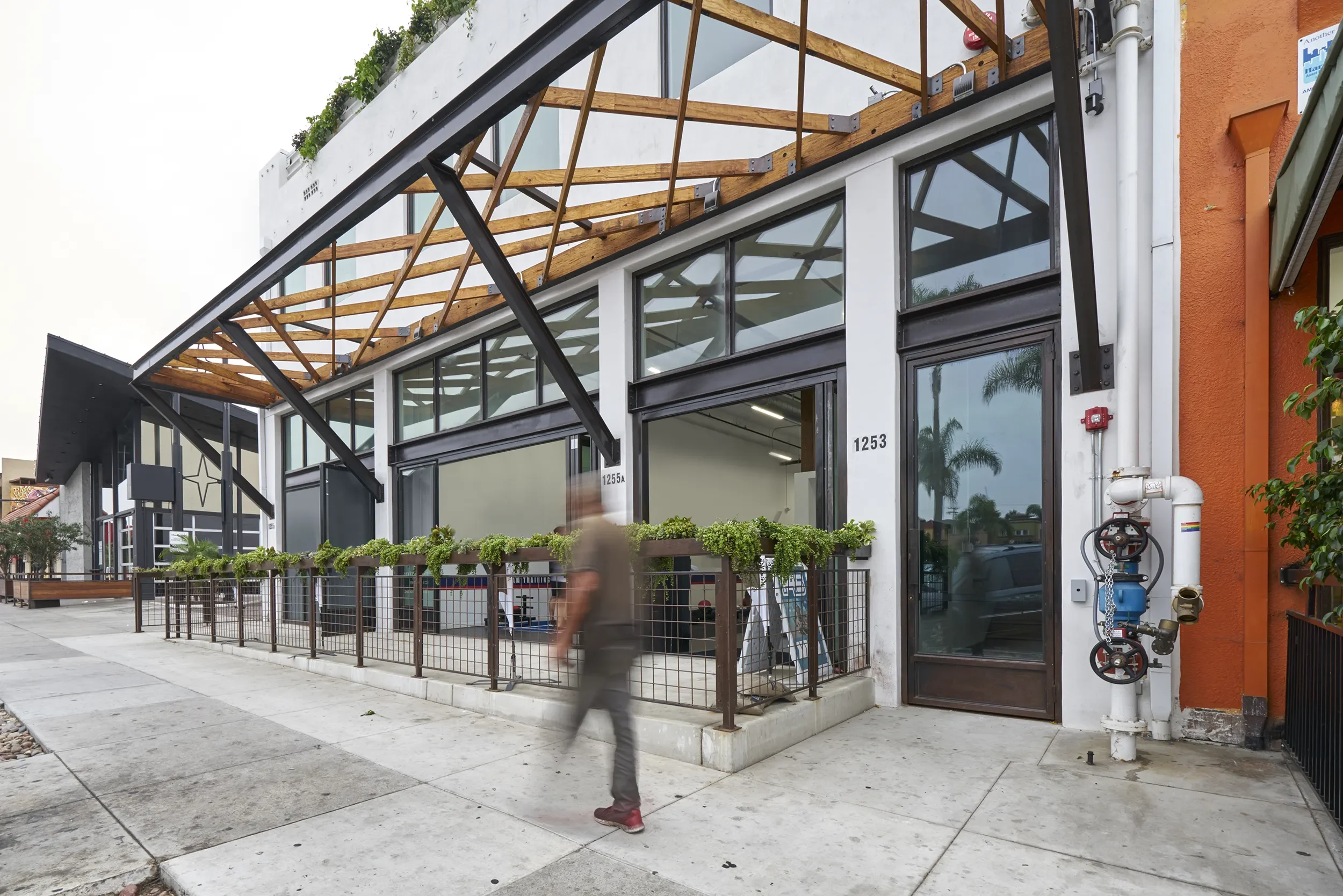 Planted steel and timber canopy along the street frontage of Uni Office Building in San Diego