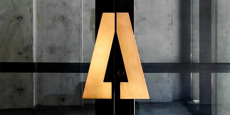 Custom brass monogram door handles at Secoya By The Park