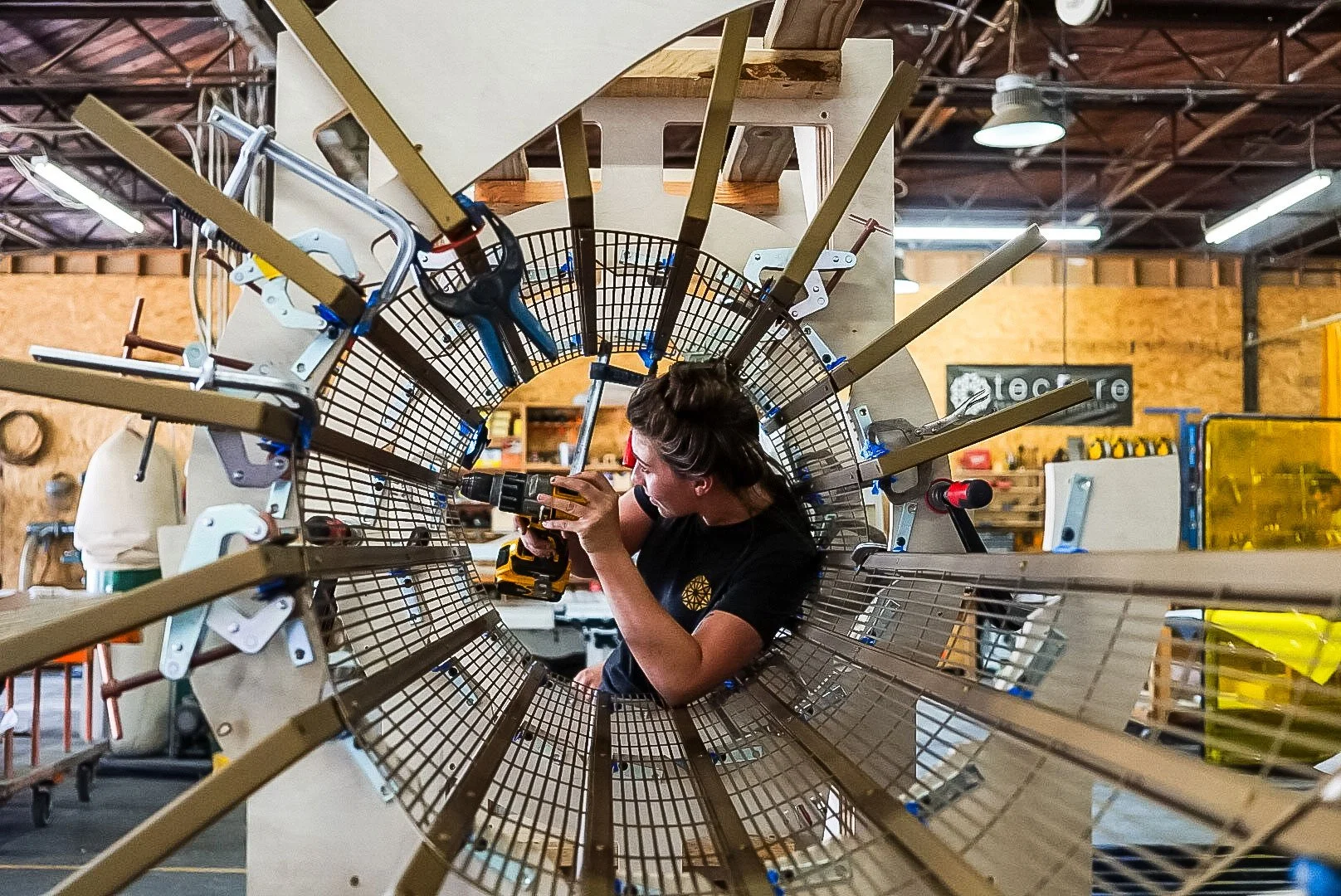 Tecture AF fabricator building and assembling the radial chandelier ceiling feature frame for Emerald Jamul Casino