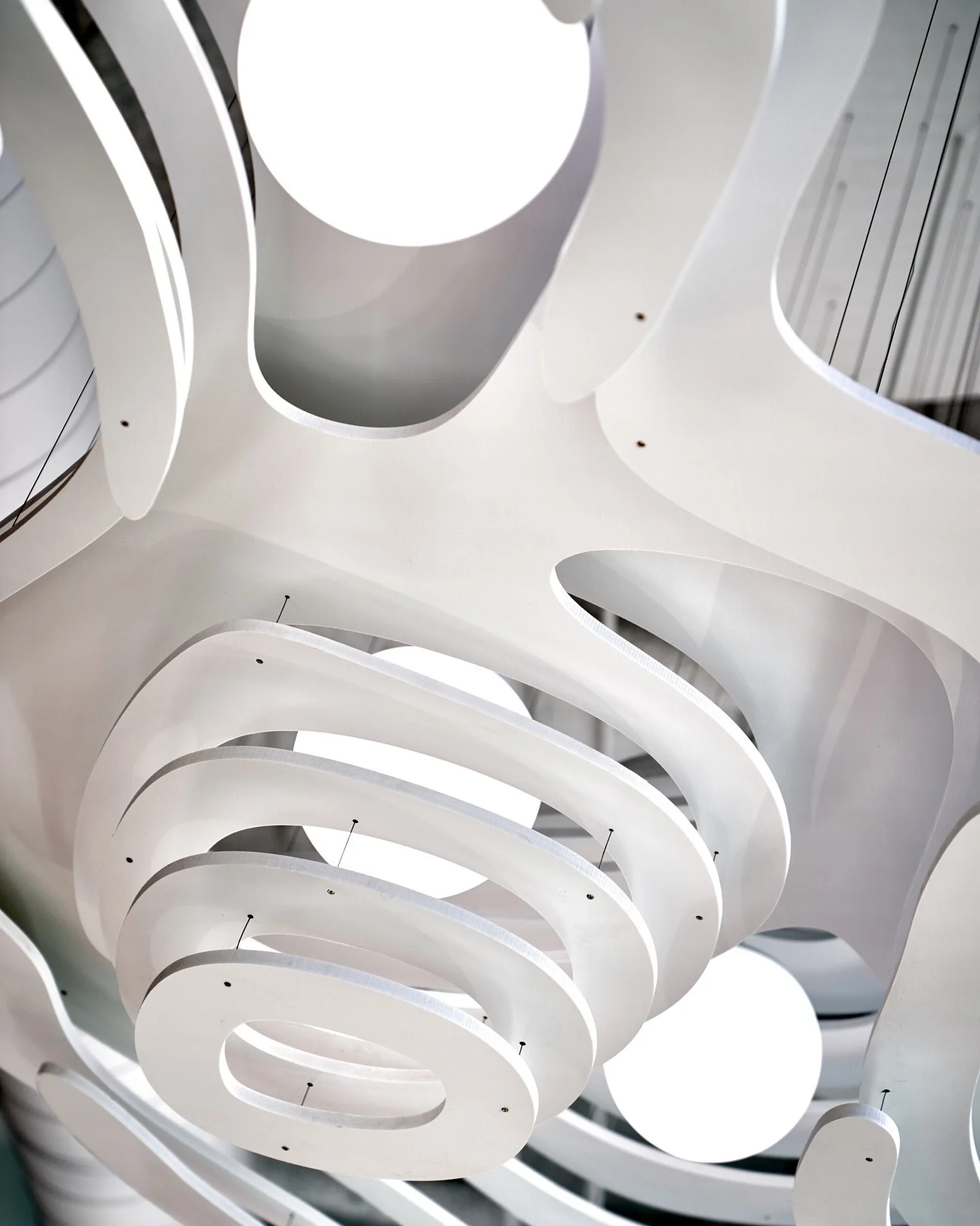 Natural forms meet modern light it Installed in a La Jolla office, this trio of custom sculptures draws inspiration from the striations of land and the softness of clouds. 

A harmonious blend of earth and sky, turning the workspace into a moment of 