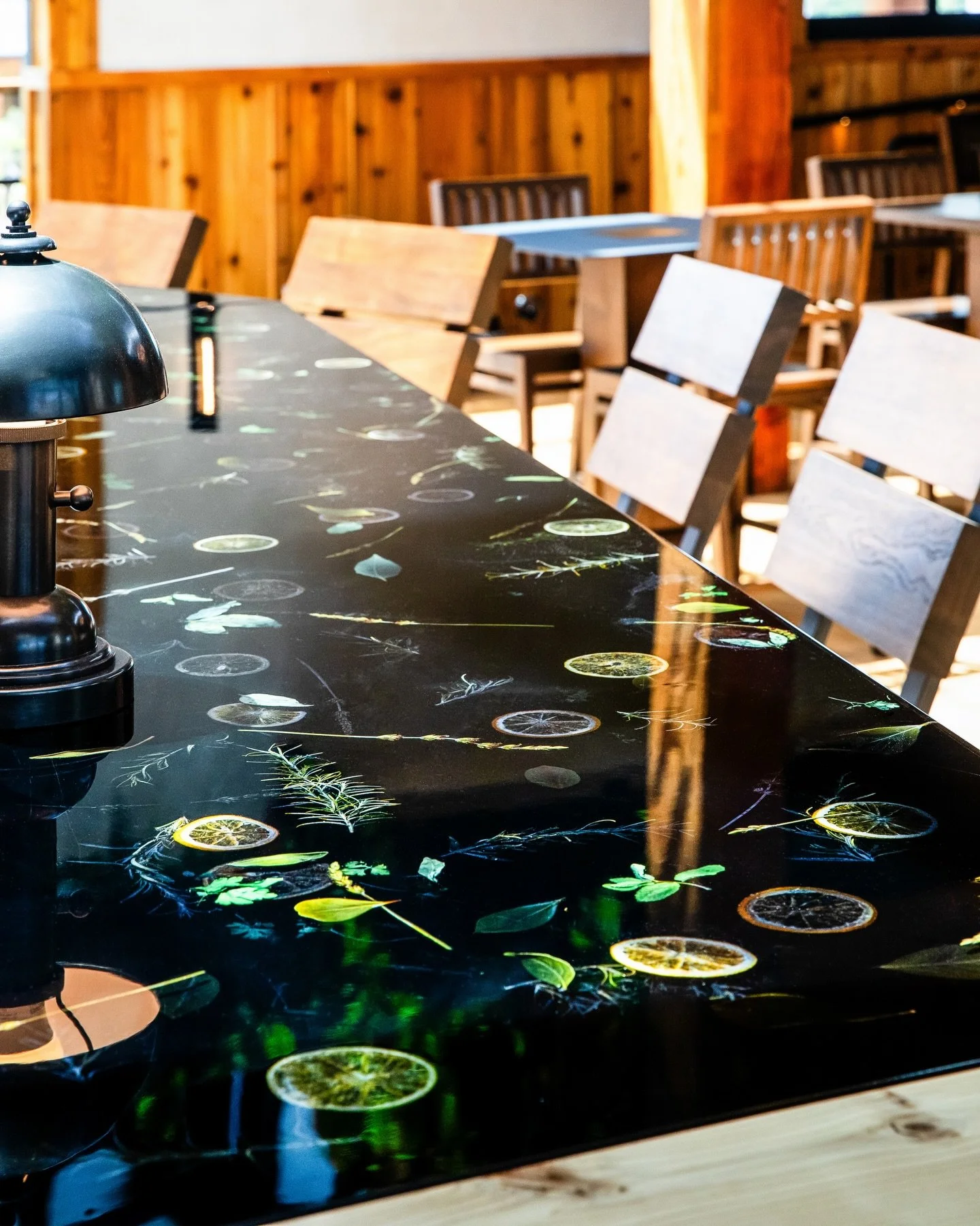 Swipe to see how this custom countertop came together.

We used real dried herbs and oranges and poured resin over them. Working with natural materials and resin-both unpredictable on their own -was tricky, but years of experience helped us get it ri