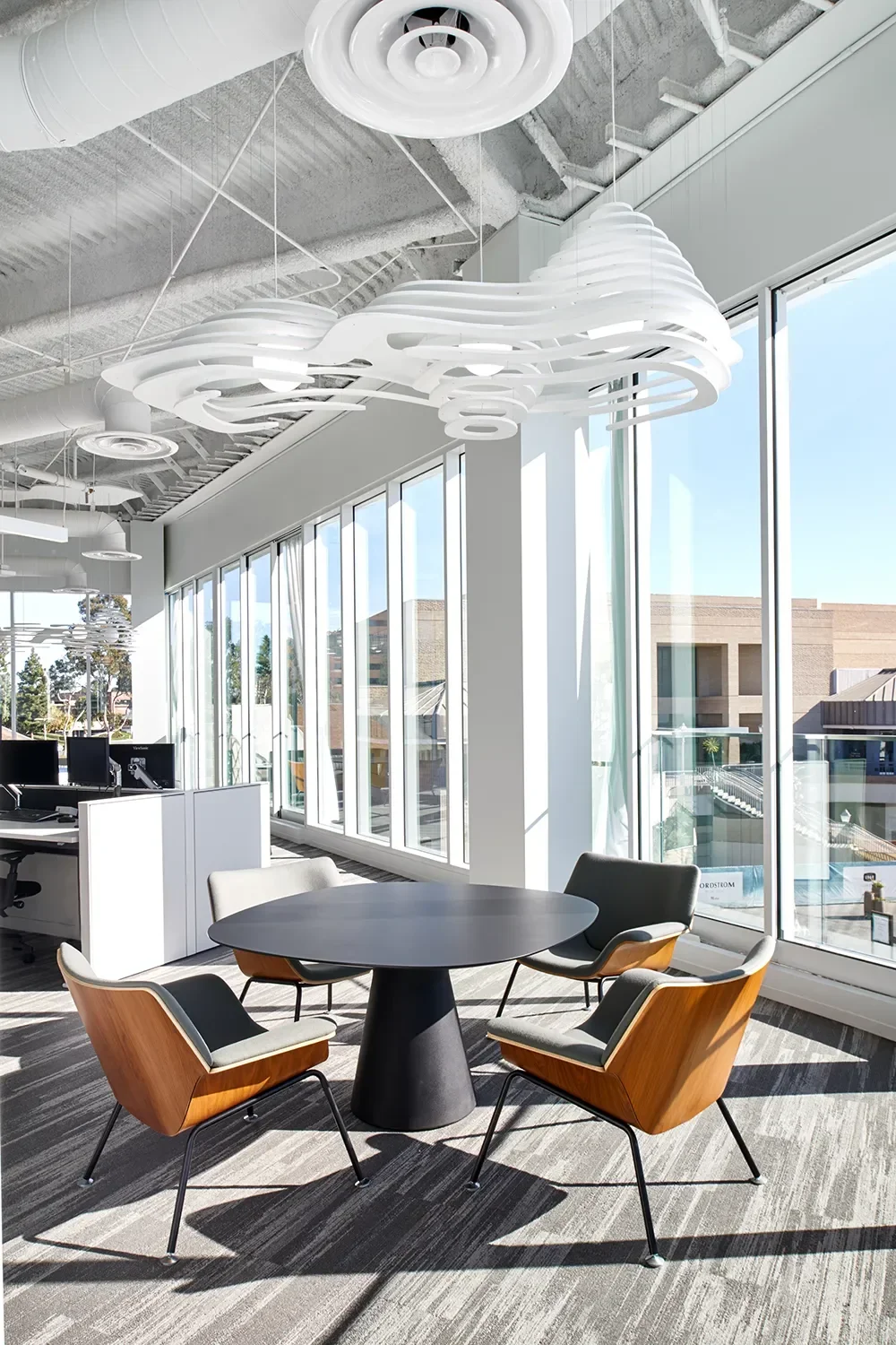 Cloud Light the sculptural white ceiling feature with integrated lighting above a relaxed meeting area