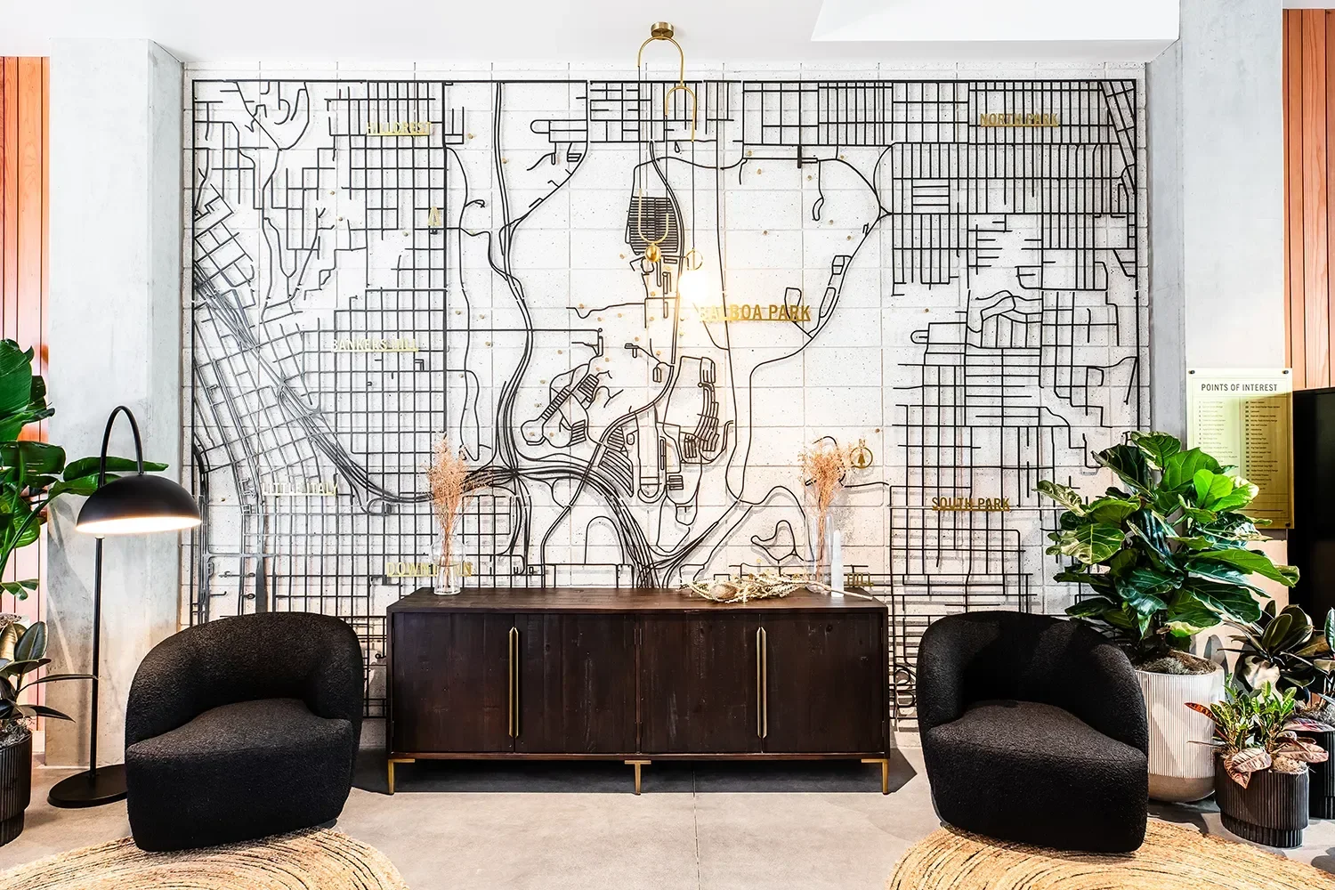 Large scale metal map art installation mounted behind a lounge space at Secoya By The Park in Bankers Hill San Diego