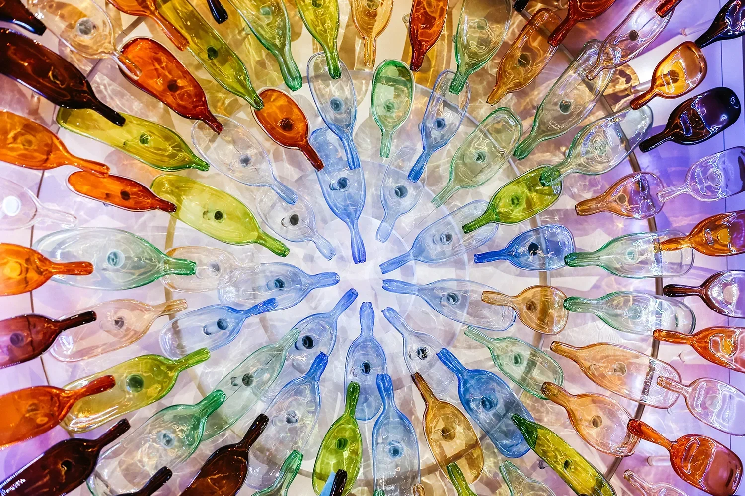 Radial burst of colored translucent glass blown forms with LED lighting for a custom art feature at Valley View Casino