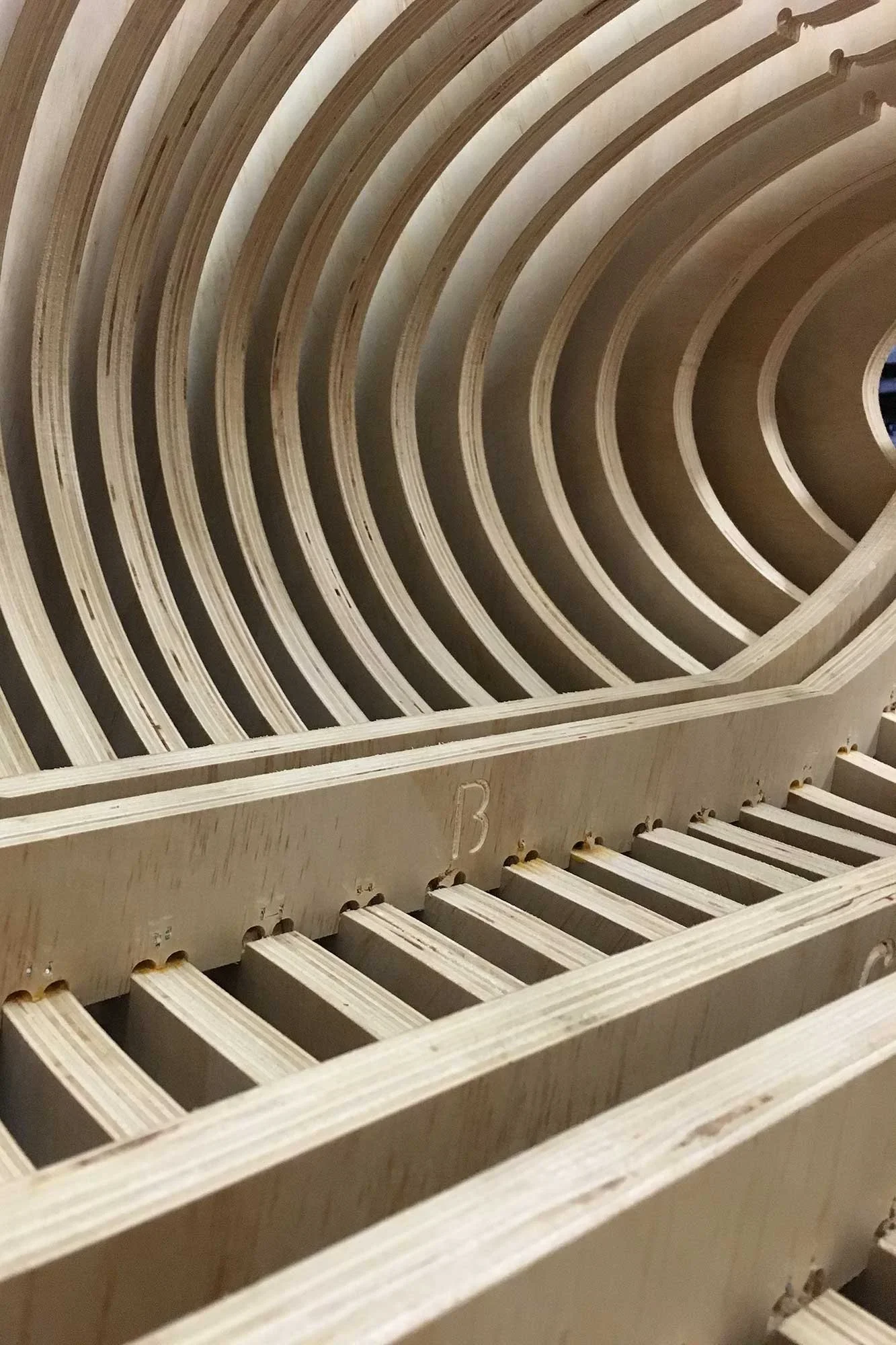 Curved slatted wood vault under fabrication on the shop at Tecture in San Diego