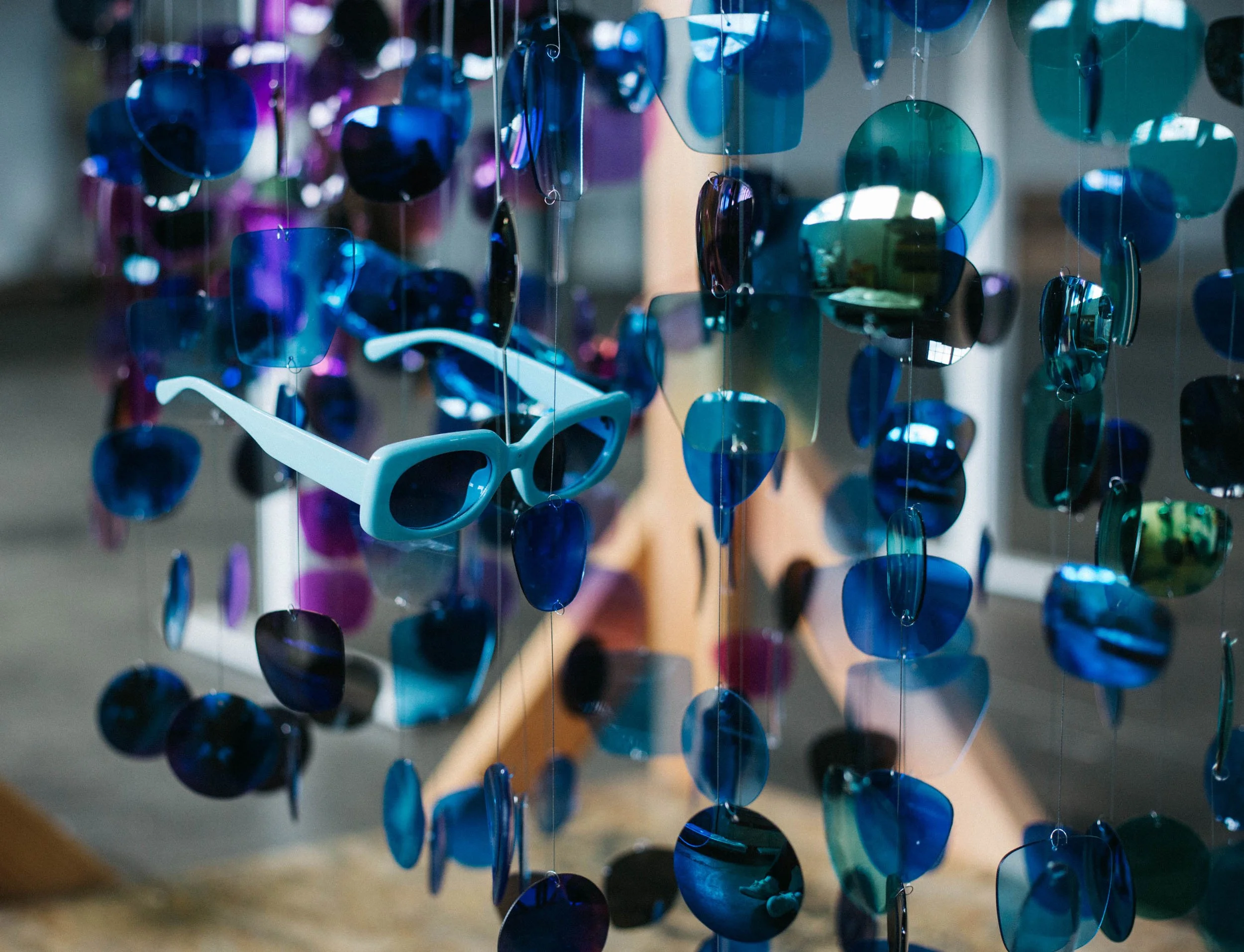 Close-up of colored acrylic pieces for a suspended sculpture for a corporate office, on the Tecture shop floor.