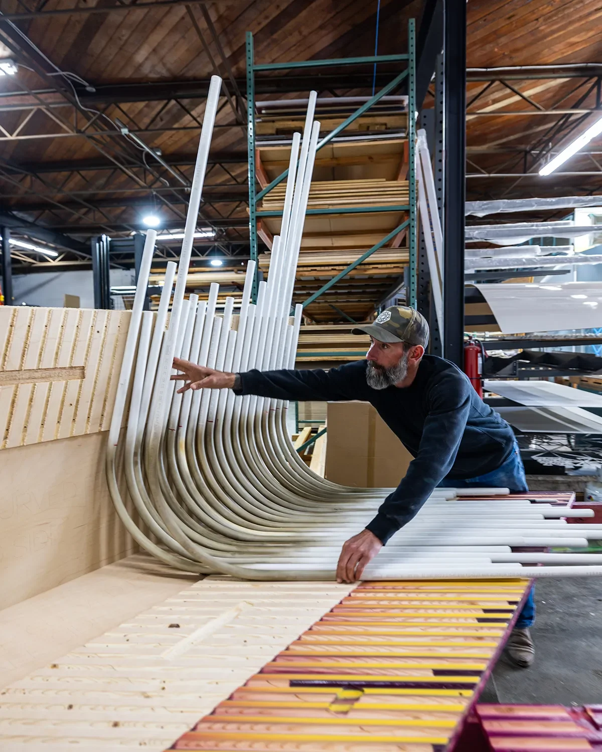 Tecture AF fabricator laying out the pvc pipes in the Tecture shop for the UCSD art installation The Glitch