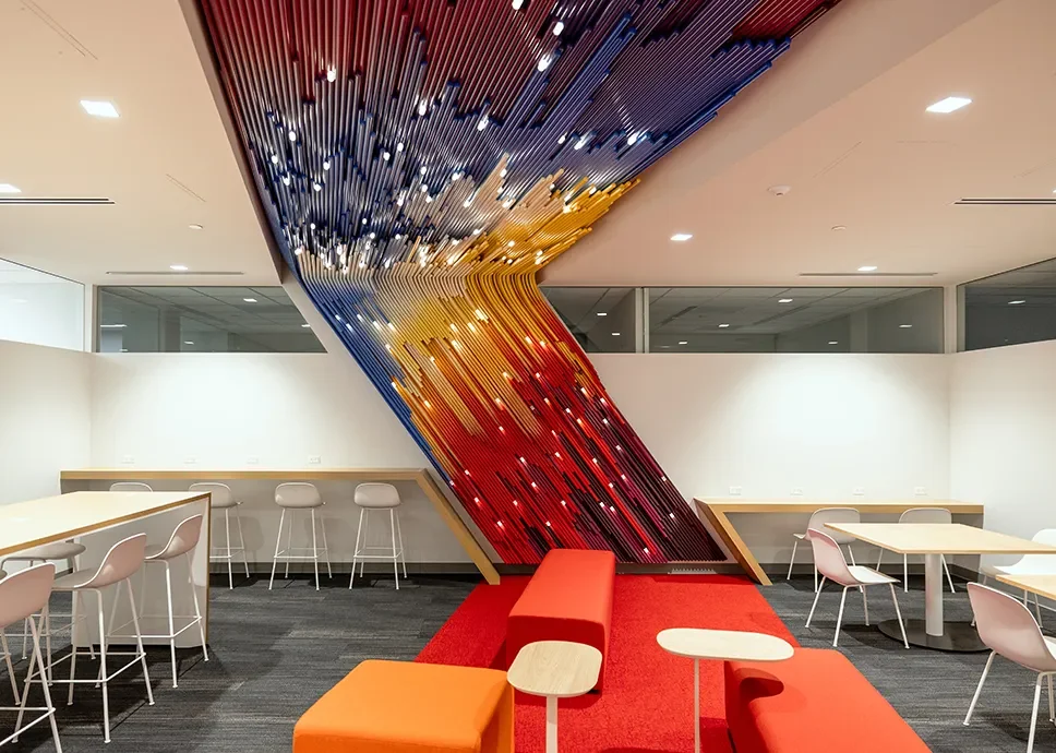 Glitch, hundreds of color treated PVC rods cutting diagonally through a UC San Diego breakout nook