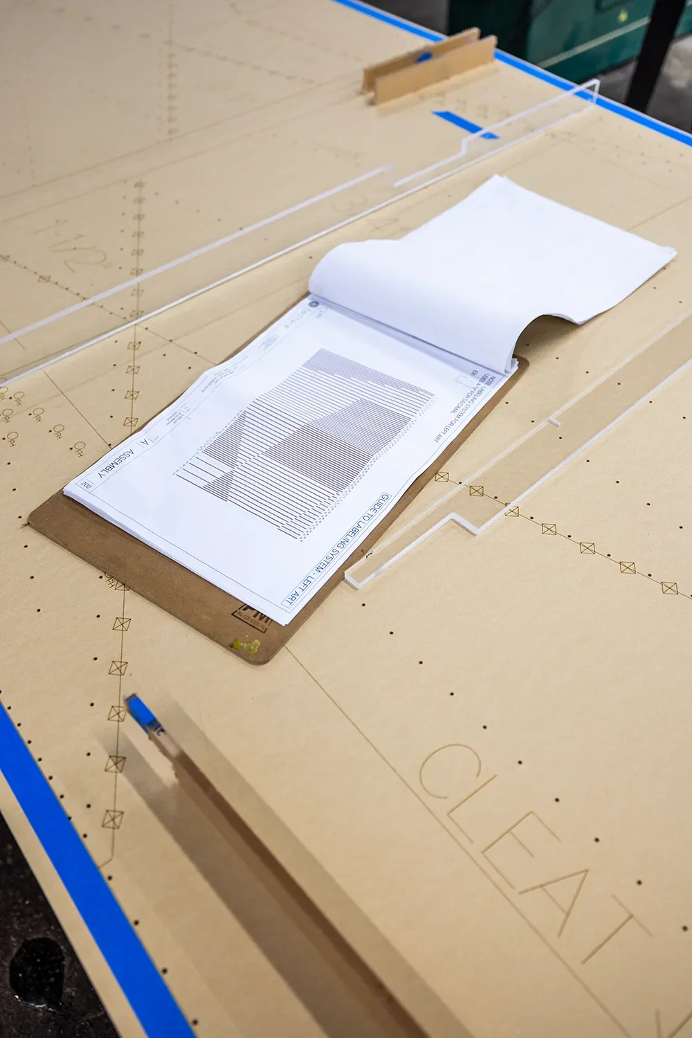 Shop drawings for The Glitch art installation at UCSD laid out on a fabrication bench at the Tecture shop