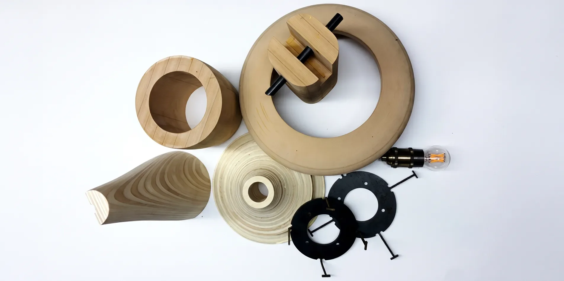 Prototype components for the Ballast Lights cast fixtures on a white backdrop