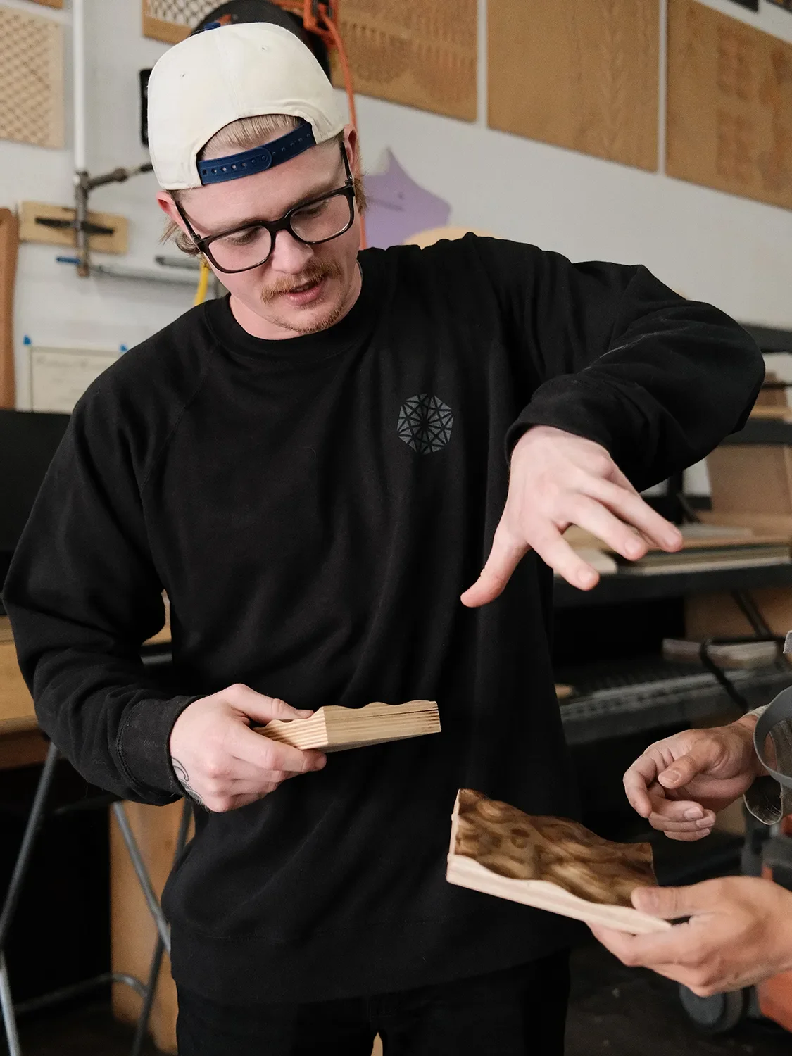 Kyle Erickson reviewing material samples in the shop to assess the quality for the client