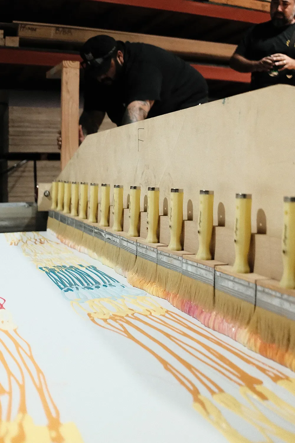 Custom brush cart rig pulling the colored paint across the panels in a single pass