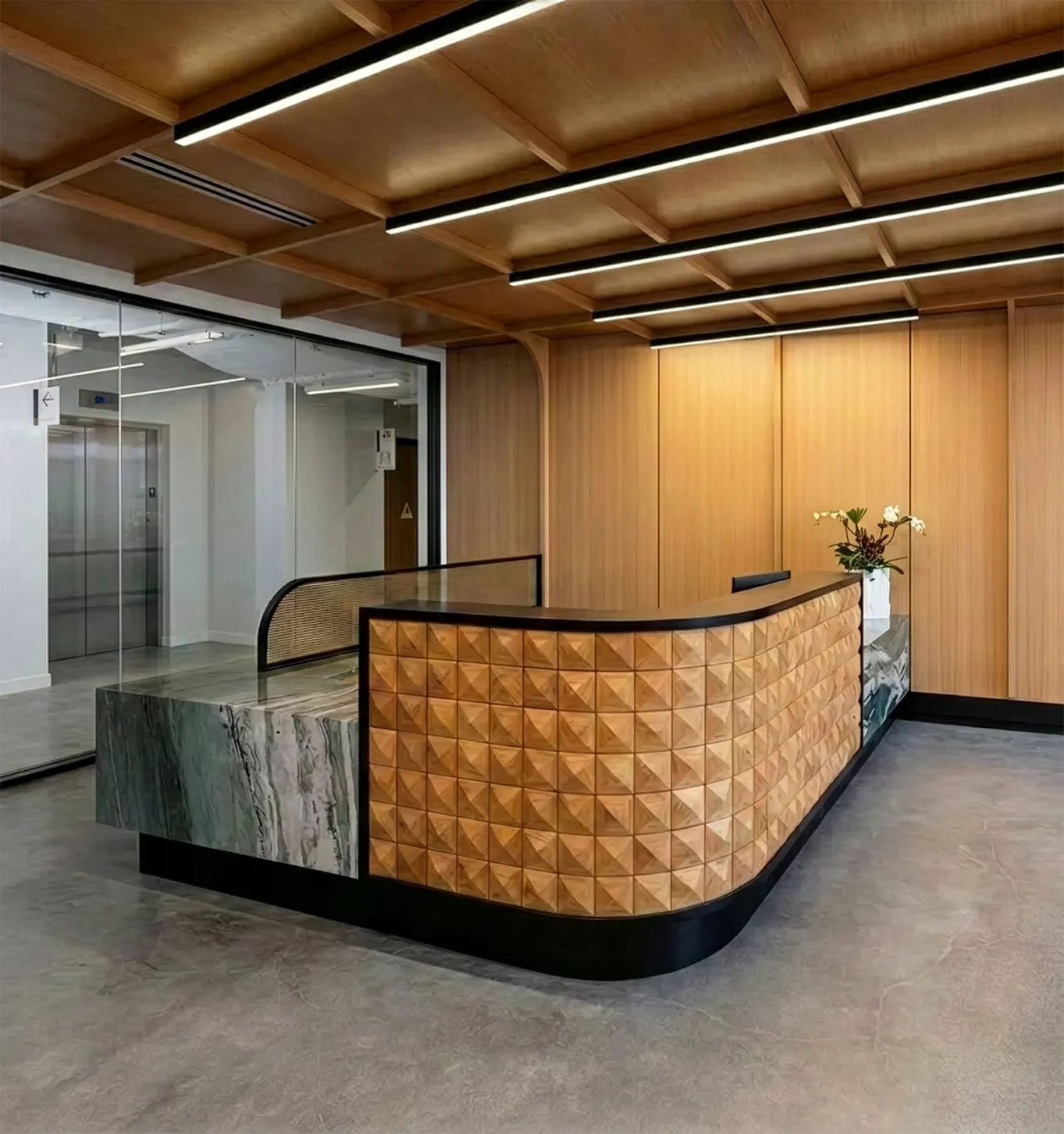 Curved wood slat reception desk built for a corporate interior, see custom furnishings.