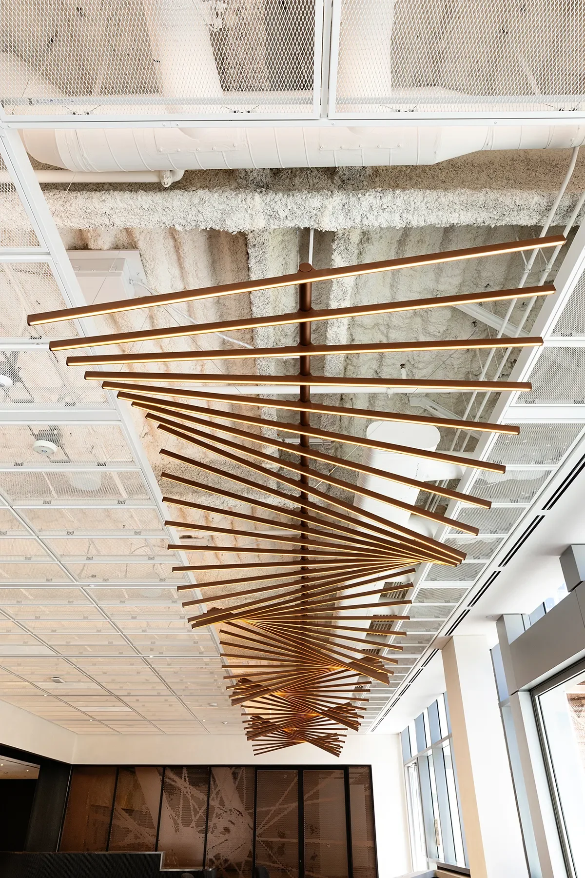 Suspended metal rod ceiling feature fanning out above a lobby space