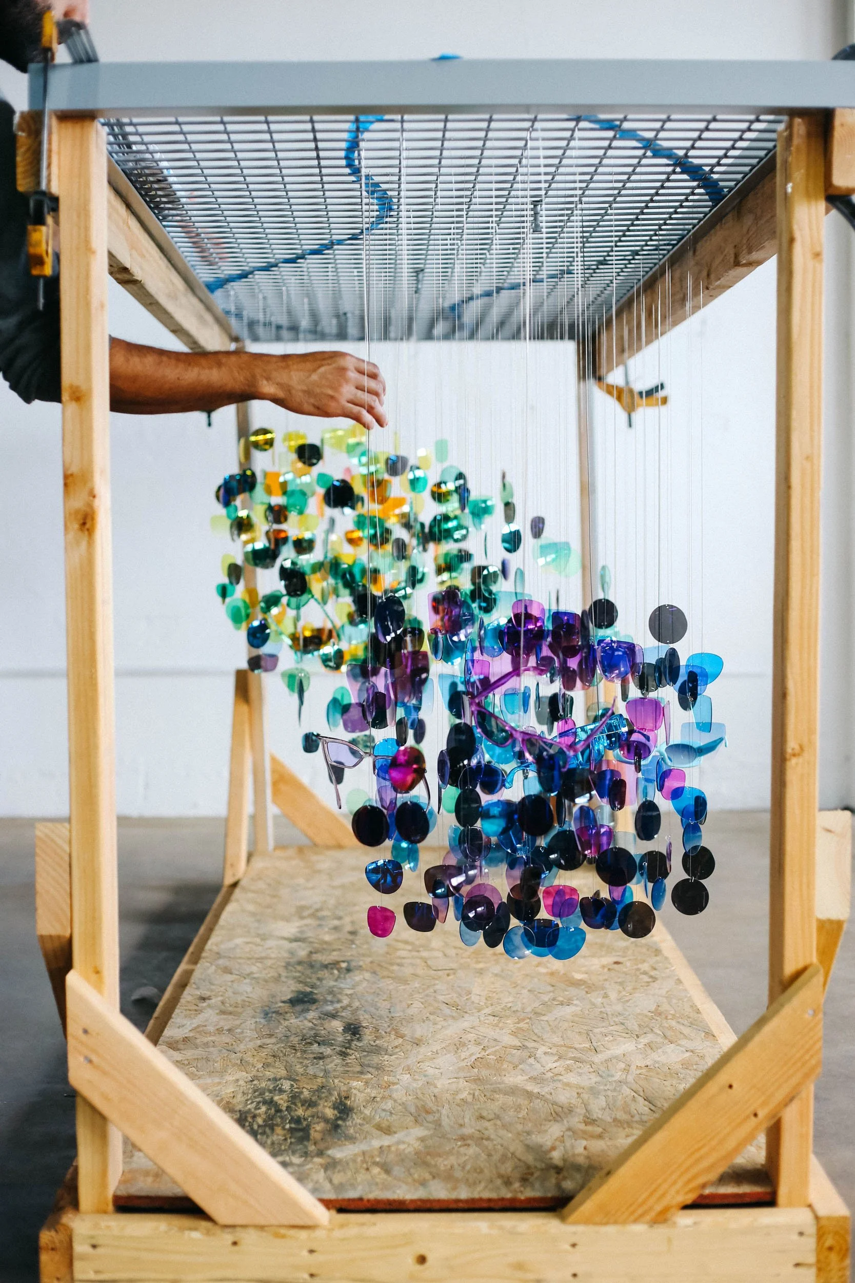A custom suspended acrylic piece sculpture being laid out and assembled in the Tecture AF shop.