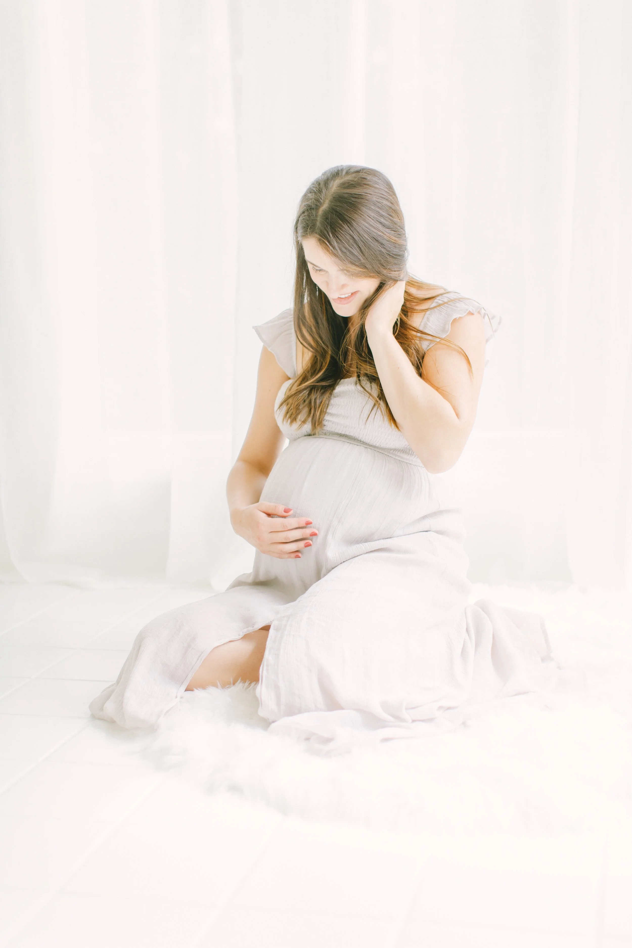 A moment of maternal reflection and inner work during pregnancy. This image illustrates the "tuning in" process mentioned in the blog—using meditation and stillness to identify needs and prepare for an expansive postpartum experience.