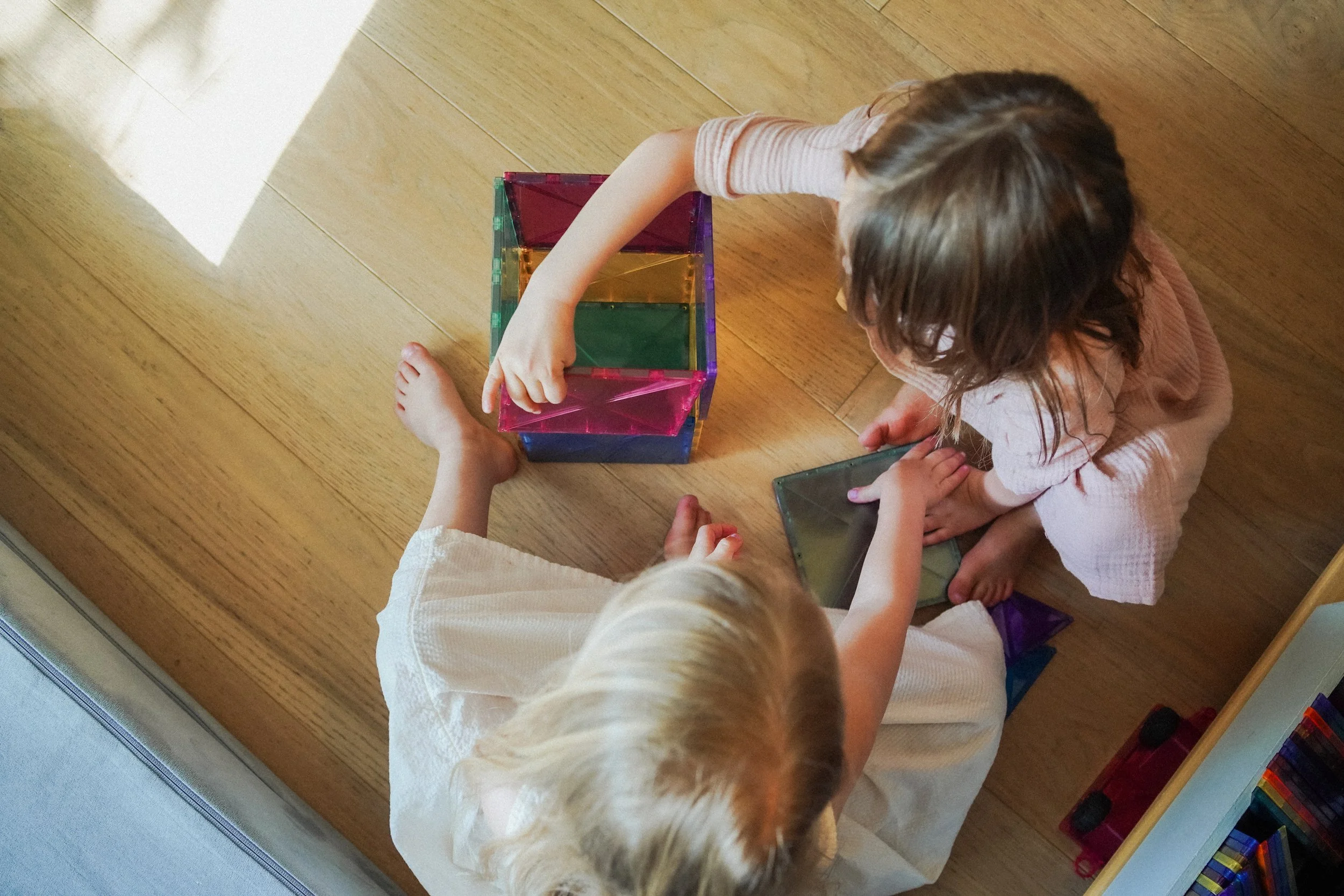 Kids building with magnetic tiles
