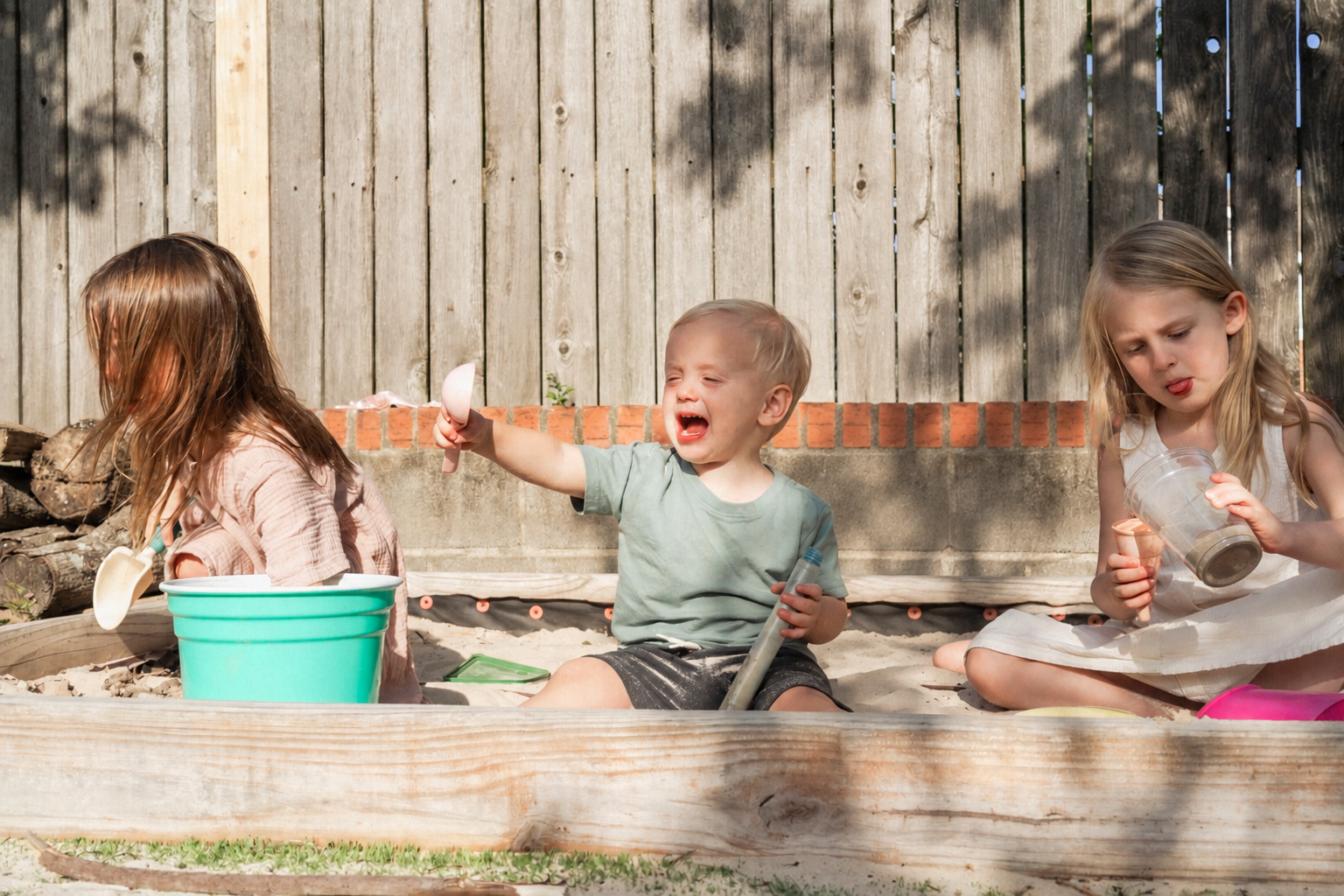 Joyful kids in sandbox