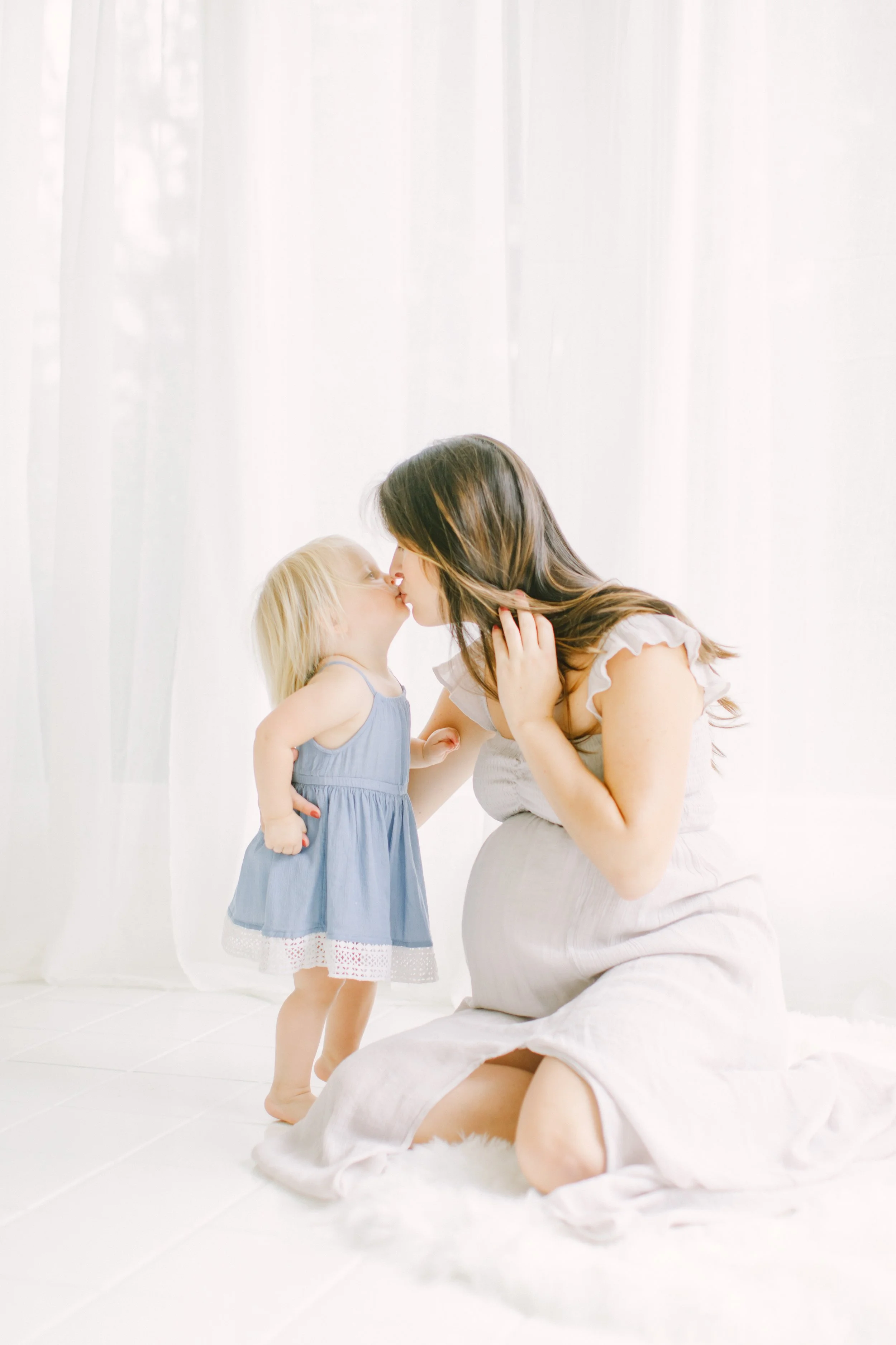 Capturing the tender connection between a mother and child during pregnancy. This image represents the transition into a new season of motherhood and the importance of staying grounded and present while expanding your family and village.