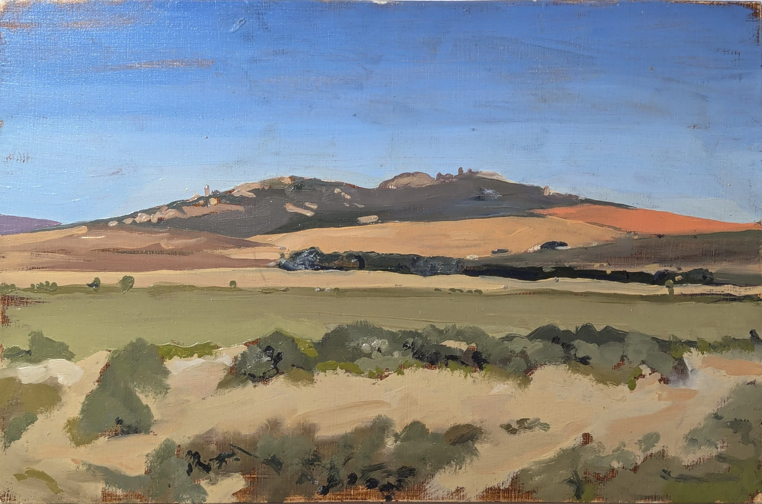 Art restoration London painting restorer. Landscape painting of hills under a blue sky with green and brown fields