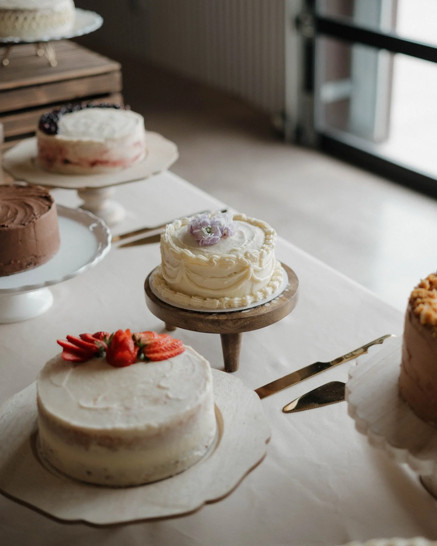 We loved seeing this different take on a wedding cake! Instead of one large cake, the couple decided to do a table full of smaller cakes with various flavors! What a creative and fun idea!