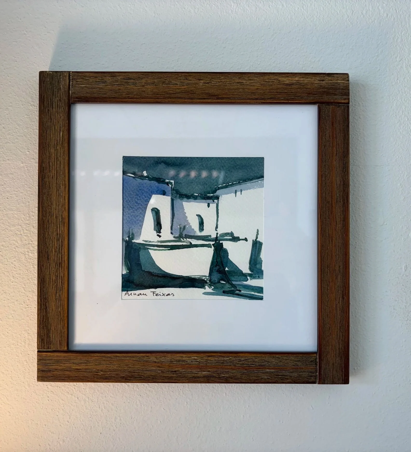 A framed watercolor of two boats, hanging in a therapy office in Santa Monica 