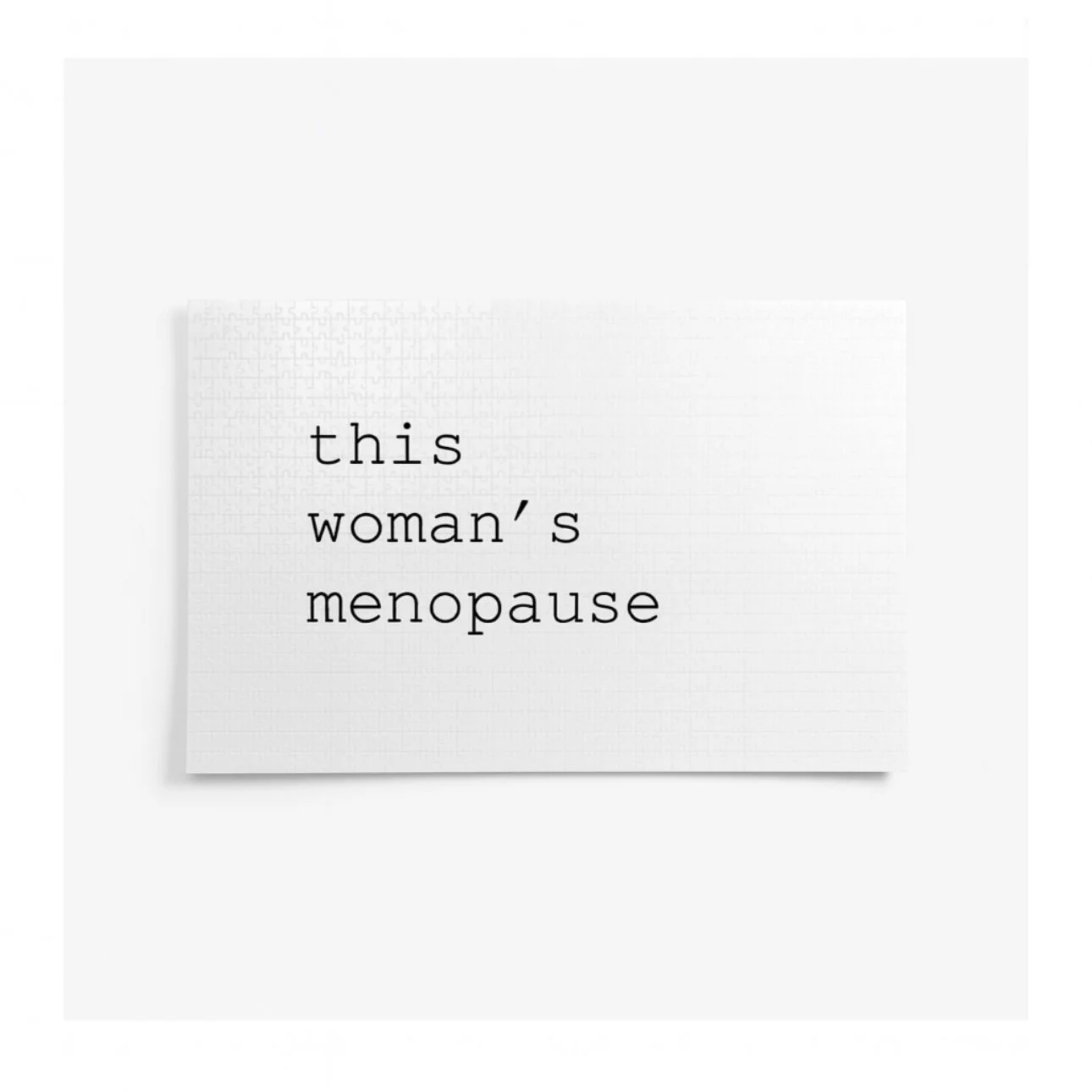 A white card with the words "this woman's menopause" typed in black lowercase letters.