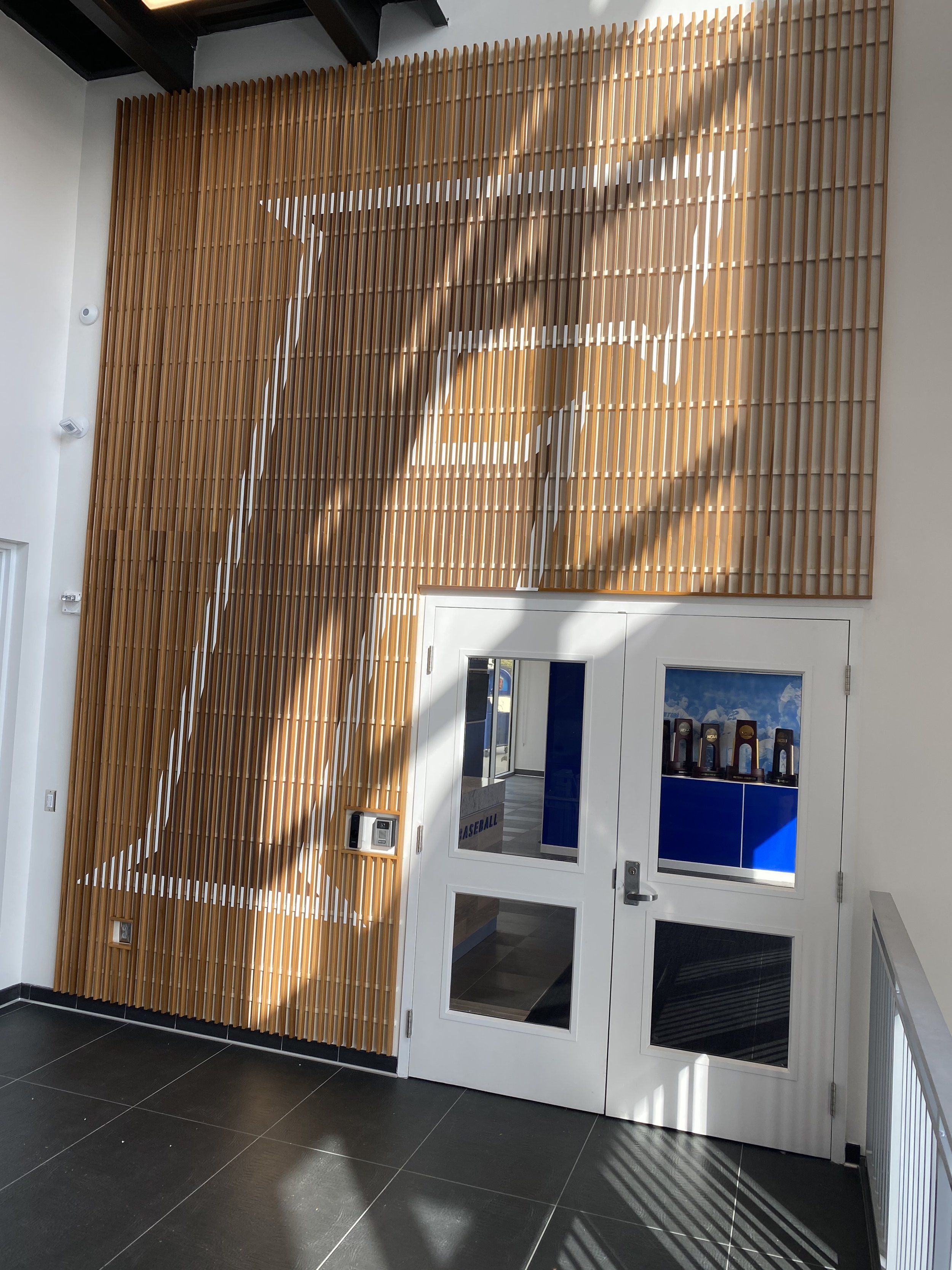 Painted letter ‘F’ for the Florida Gators on a brick wall leading into a gymnasium