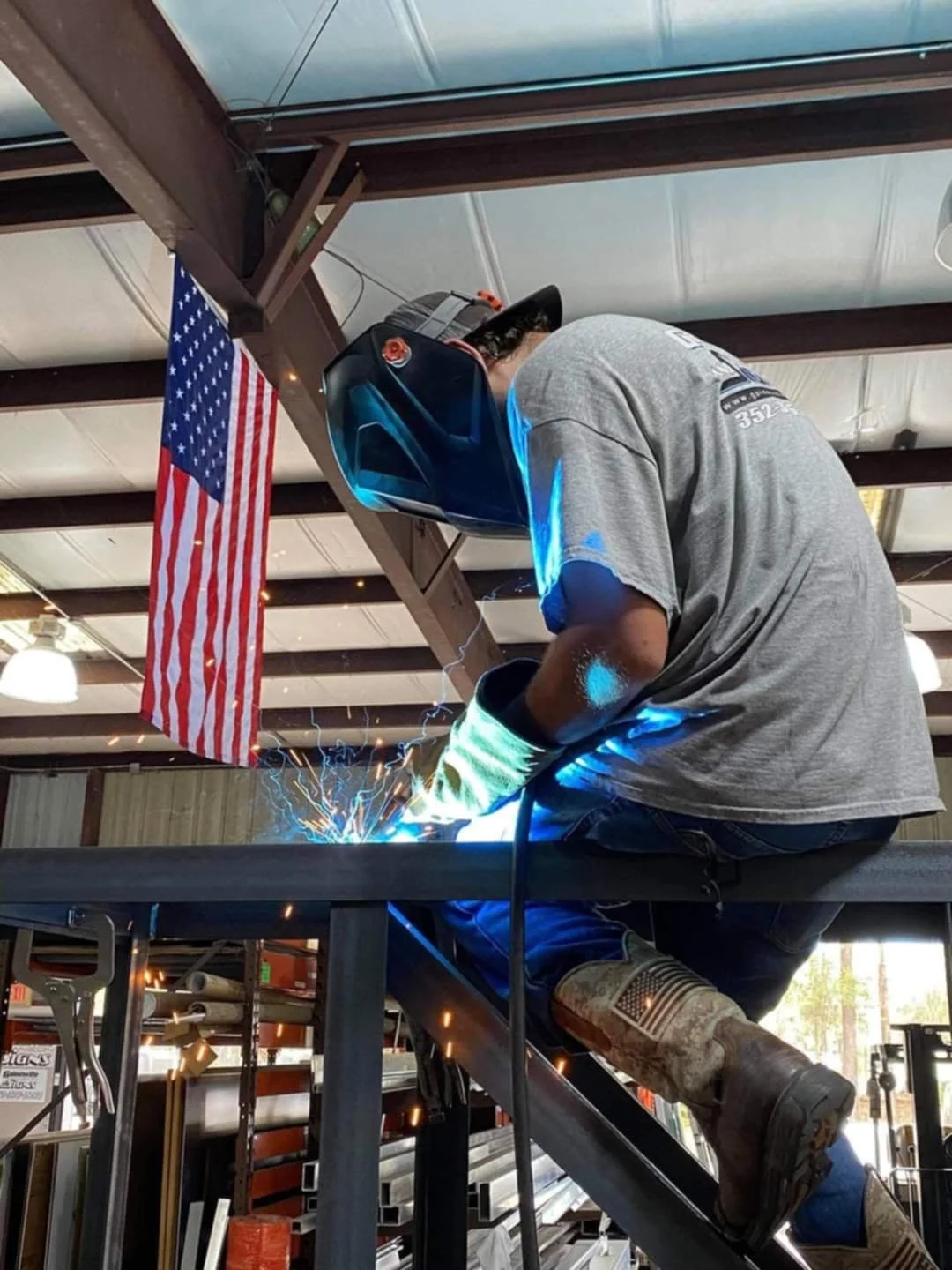 Technician welding a custom metal sign