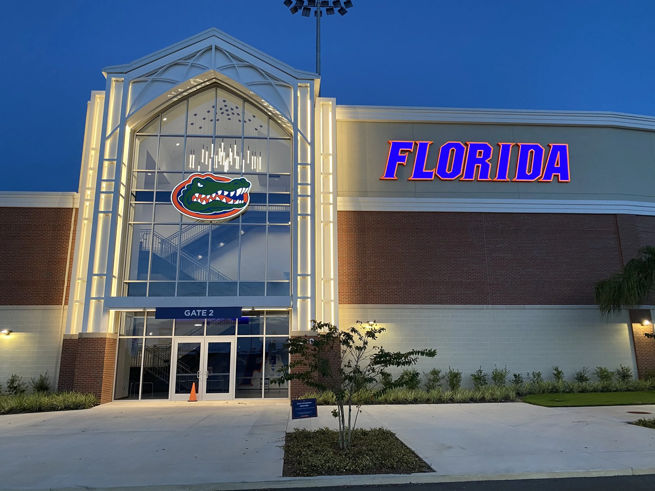 Florida Gators neon sign displayed outside the main entrance of a gymnasium